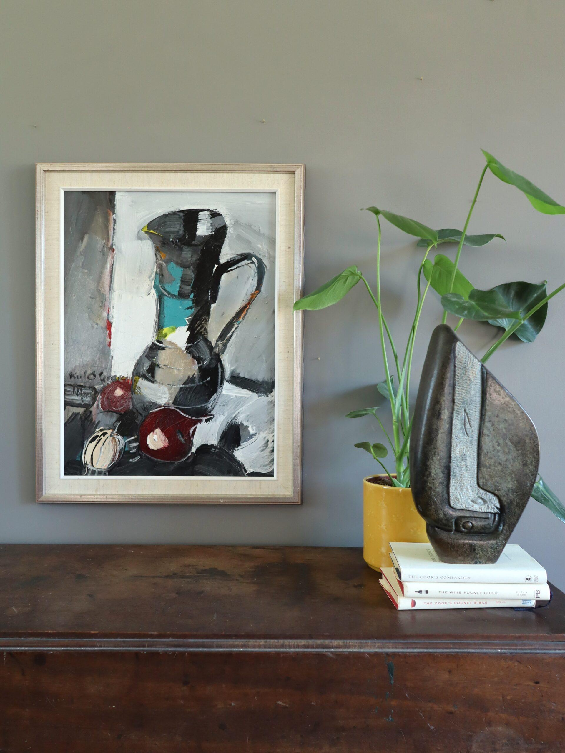 PITCHER WITH ONIONS
Size: 64.5 x 50.5 cm (including frame)
Oil on board

An energetic mid-century still life painting that depicts a bold arrangement of everyday objects rendered with expressive confidence, executed in oil onto board.

At the center