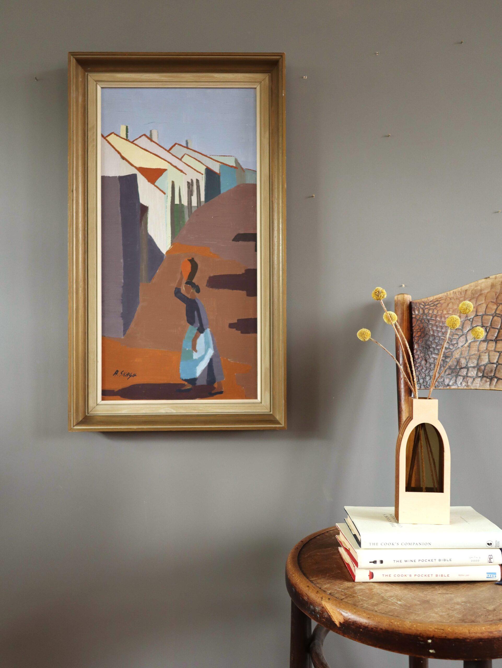 VILLAGE PATHWAY
Size: 71 x 49.5 cm (including frame)
Oil on board

A striking mid-century modernist painting that captures a female figure walking along a village pathway, gracefully balancing a vessel on her head, executed in oil onto board.

The