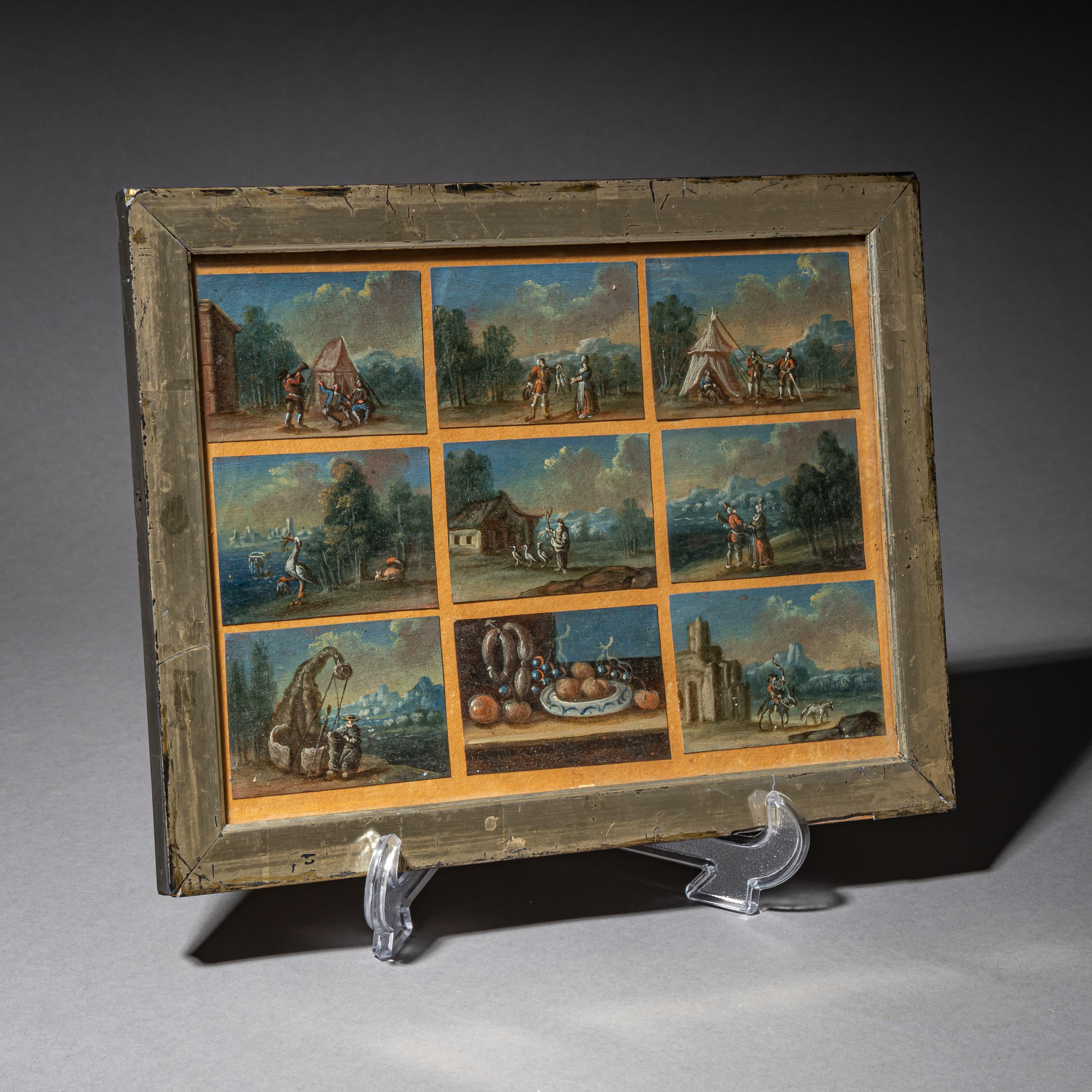 Un gruppo di nove dipinti a olio su cartone in miniatura finemente eseguiti, incorniciati in una semplice cornice di legno. I soggetti spaziano da scene di paesaggio con soldati ad anatre in riva al fiume e una natura morta. Il retro dell'opera