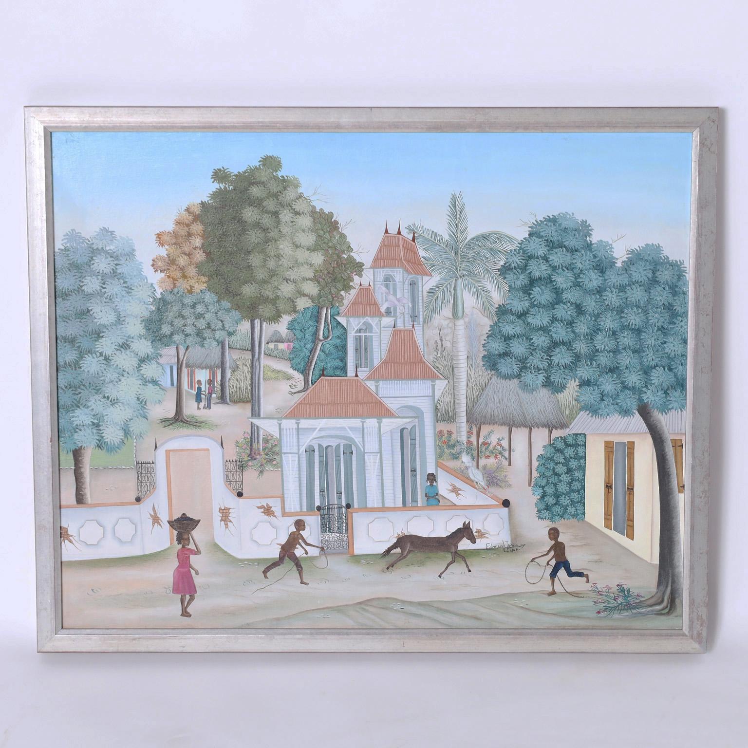 Enchanting oil painting on canvas depicting a serene Haitian village with trees, flowers, birds, and playful figures executed in a naive folk style. Signed by noted artist Edouard Tran and presented in a silver leaf wood frame.