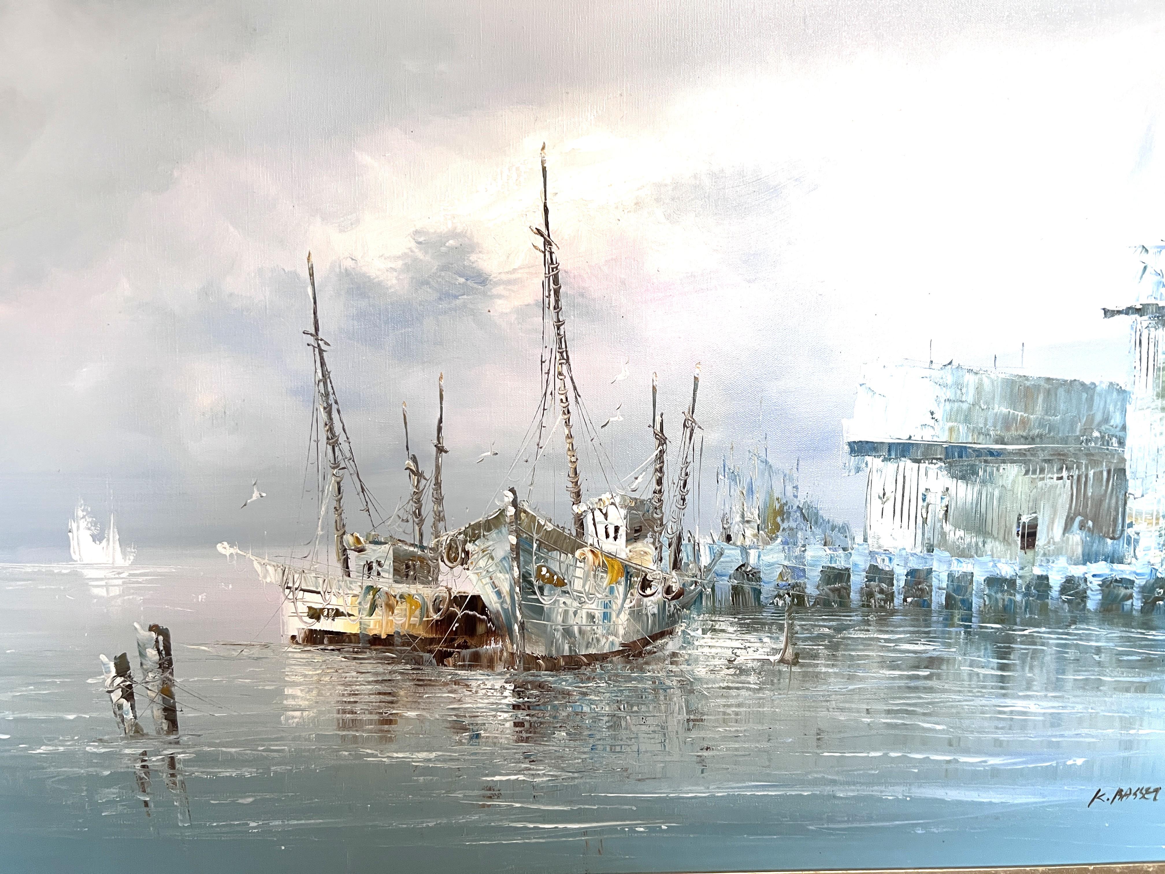 This original oil painting on canvas by artist K. Rasset captures a serene and atmospheric harbor scene. Two docked fishing vessels rest against a quiet pier under a soft gray sky, with moody reflections rippling across the calm water. The muted