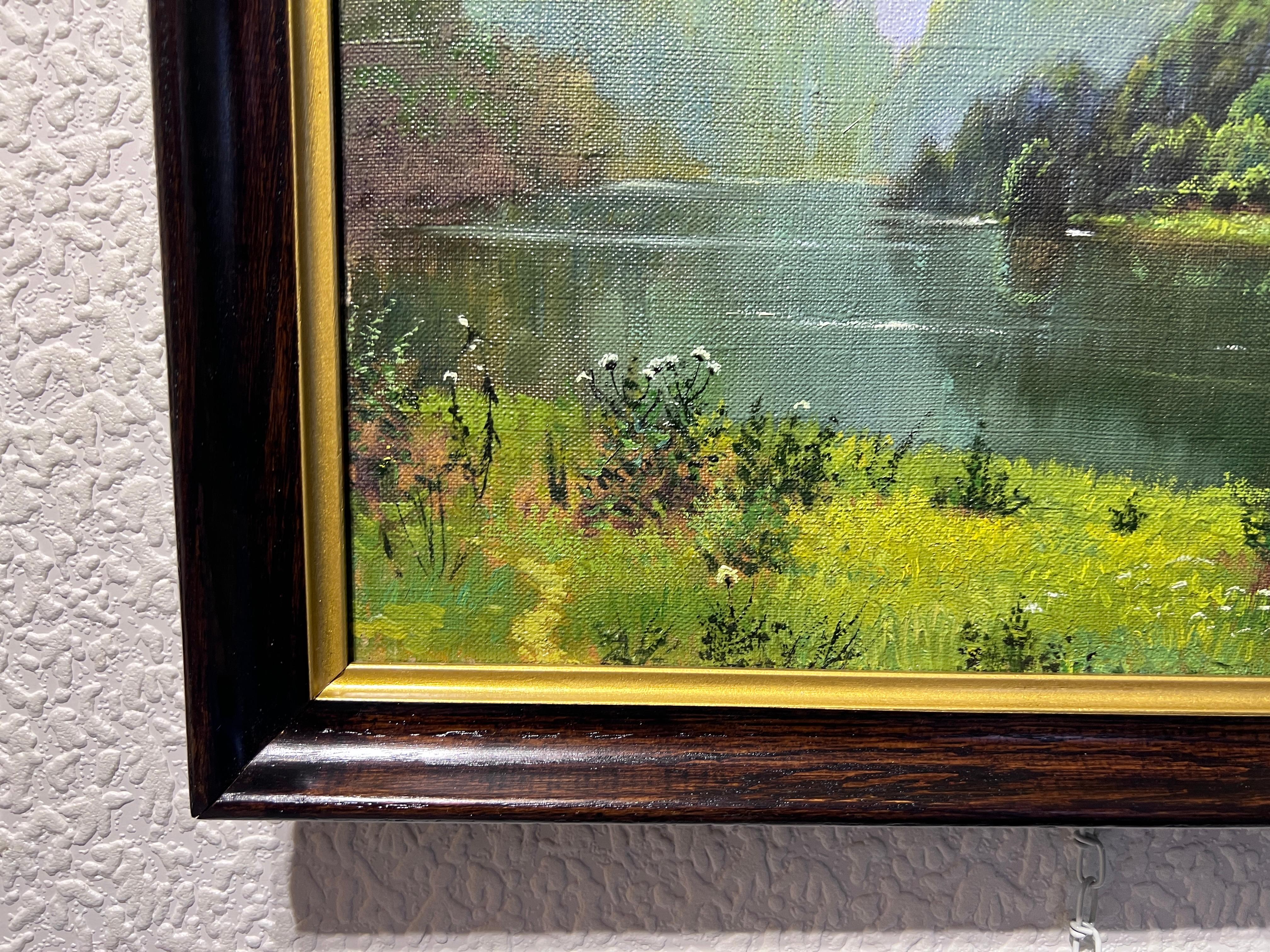 This original vintage oil painting on board depicting a tranquil Russian landscape, characterized by a gentle river that meanders through a densely wooded area. 

The lush greenery of the trees reflects vividly in the calm, clear waters, adding a