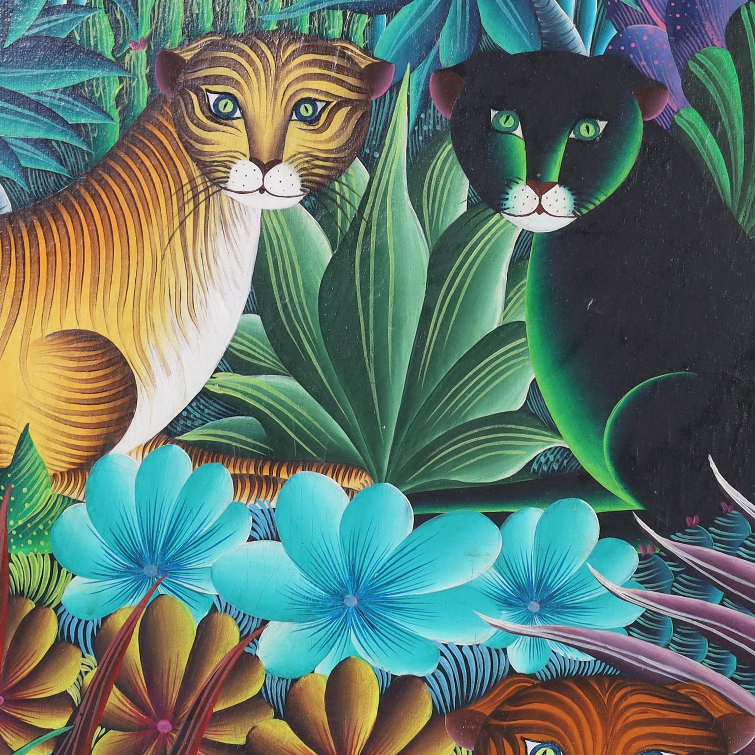 Peinture acrylique haïtienne sur toile représentant de grands félins stylisés dans un décor de jungle luxuriante avec des arbres fruitiers, des palmiers et une flore tropicale variée. Signée par l'artiste de renom M.Paul et présentée dans un cadre