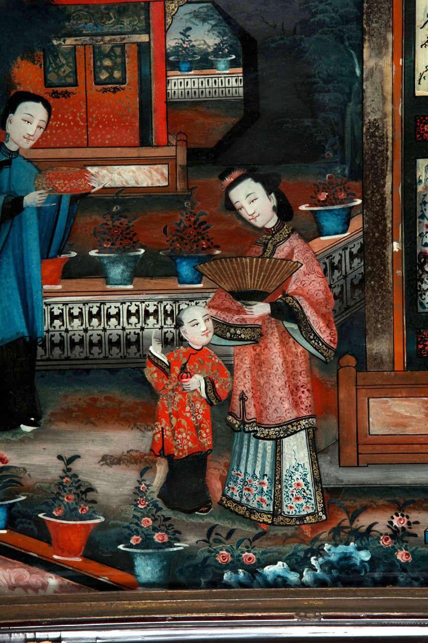 A pair of Chinese reverse glass painting representing women and a child in a garden pavillion. Original 