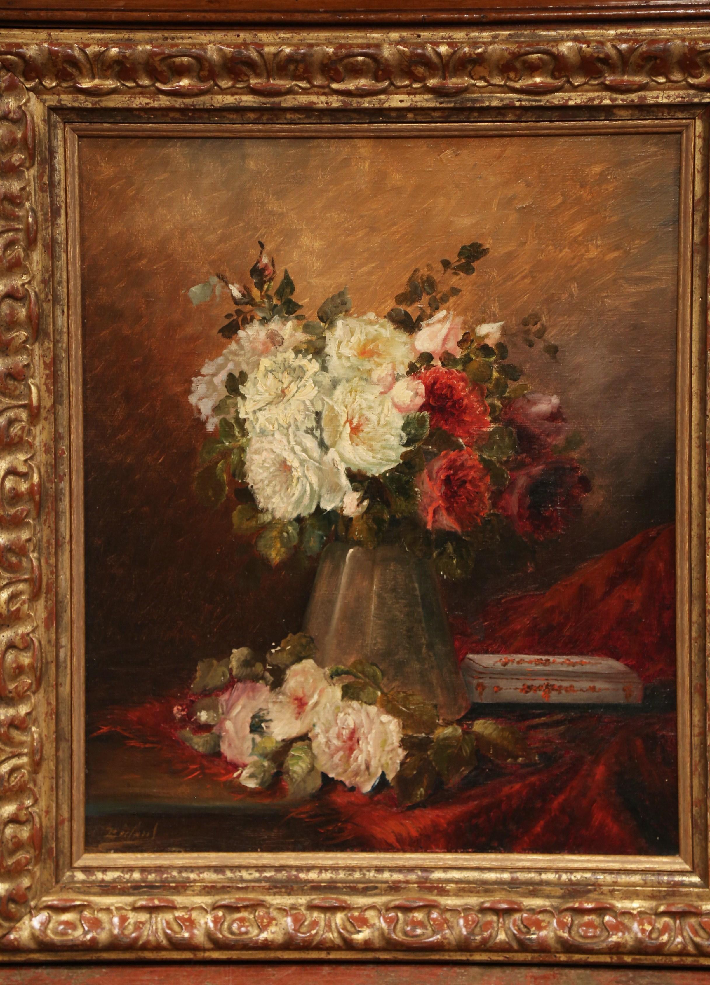 Invite color into your home with this traditional pair of antique, floral paintings. The paintings were crafted in France circa 1870 and are set in carved gilt frames. Each canvas features a vase on a table filled with colorful flowers. The