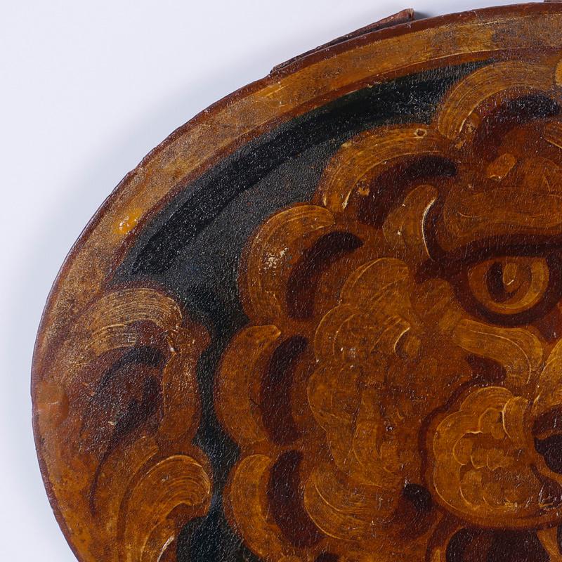 Pair of antique oil on board oval panels portraying folky whimsical lion heads. These panels are architectural remnants possible from a circus car.