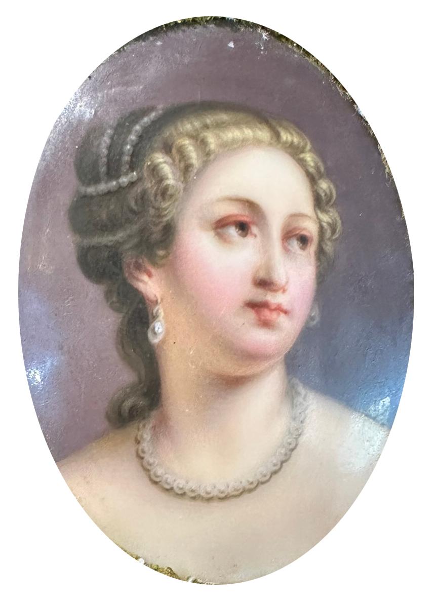 Exceptional porcelain plaque of a beautiful lady mounted in an ornate Italian giltwood baroque style frame, dating back to the early 1900’s. Frame measurements are 8.5
