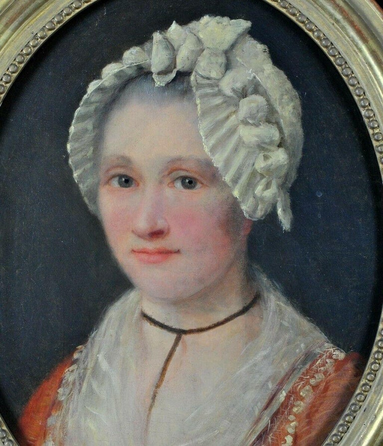 A beautiful 18th century French oil on canvas portrait of a lady wearing an orange dress with white lace trim and a white bonnet. Lovely quality portrait which is in very good condition and presented in its original gilt frame. A very pretty period