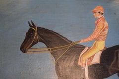 Lachsrosa Seiden Jockey reitet auf Rennpferd
