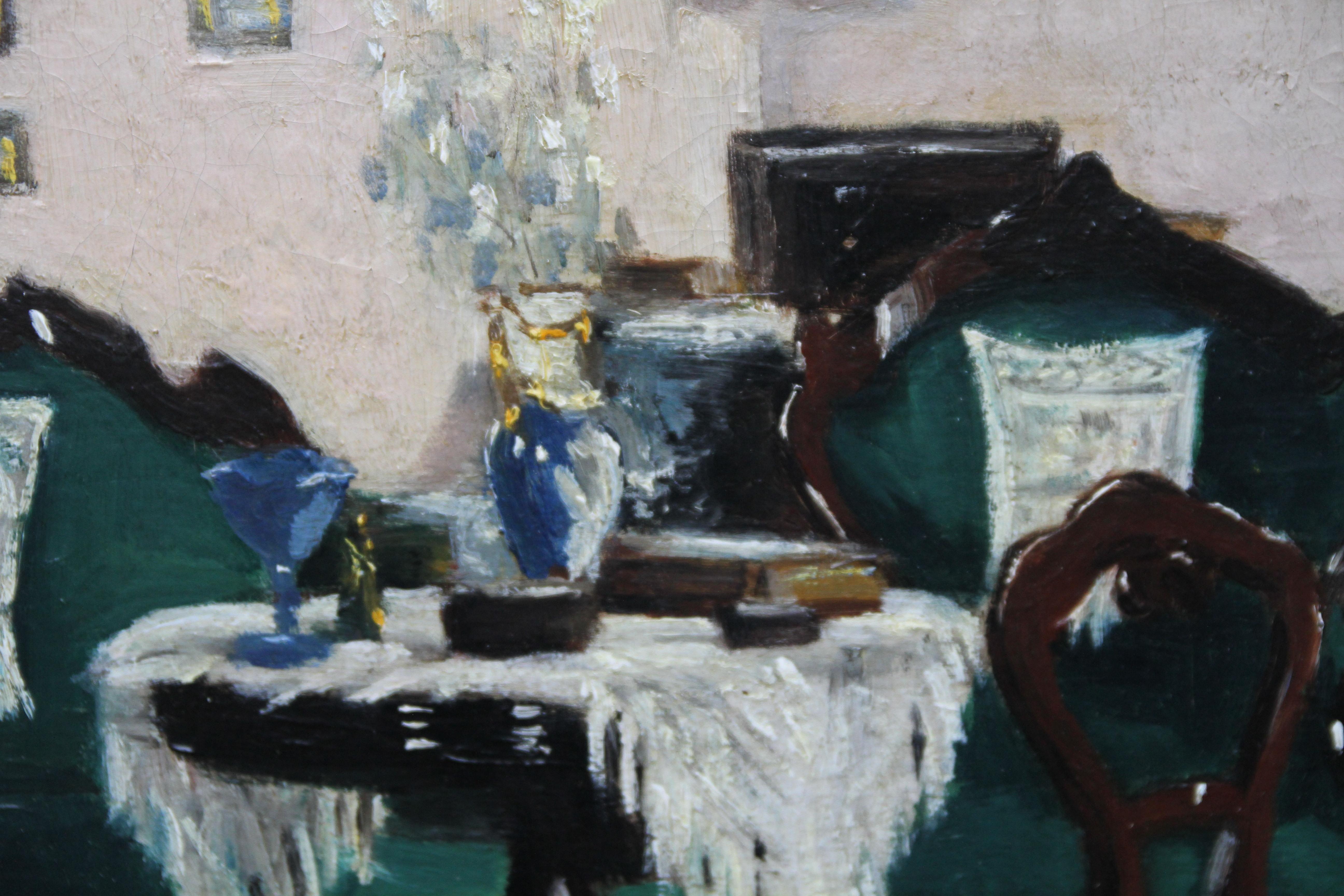 This stunning oil painting was painted circa 1911 and is signed lower right. The painting depicts a Scottish interior- a small occasion or card table surrounded by a variety of mahogany chairs upholstered in a gorgeous peacock green velvet. Various