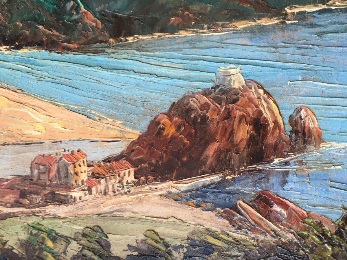 This striking oil painting, estimated from around 1940, portrays a rugged yet serene Mediterranean coastline. The rich, textured application of paint and the luminous depiction of the sea's reflective surface recall the techniques of French