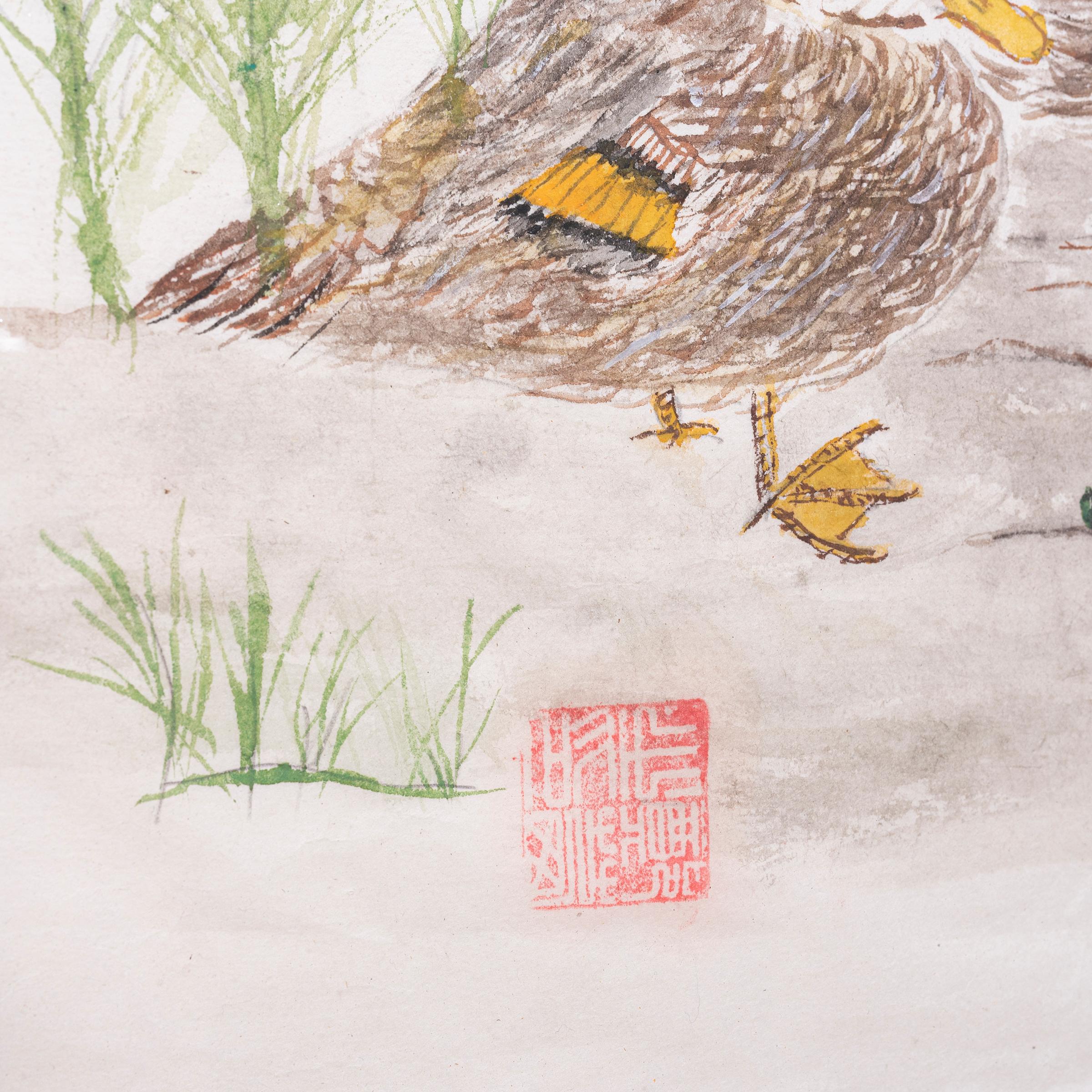 This charming watercolor is composed in the style of traditional ink calligraphy and depicts two ducks resting on a river bank. Tall grass and leafy sprouts dot the rocky terrain and calm waters lap against the shore. The small painting is set