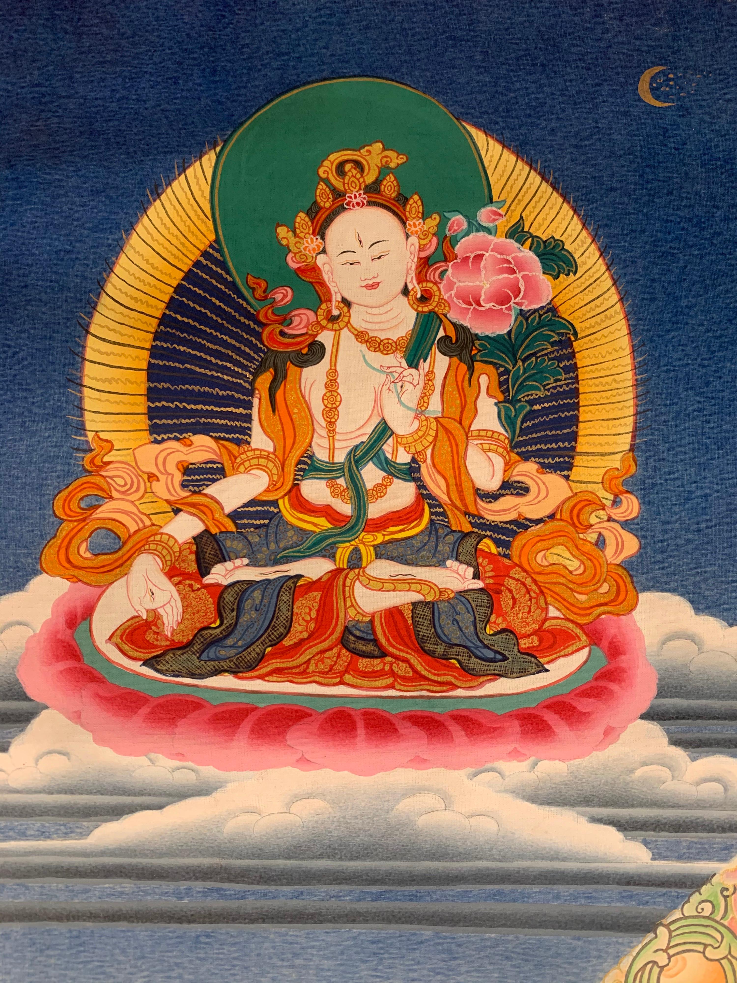 This thousand-armed Avalokitesvara thangka is hand painted by highly skilled artisan. It is painted on canvas with real 24 carat gold. There are five different deities, the protectors, around the main figure 
Avalokitesvara vows never to rest until