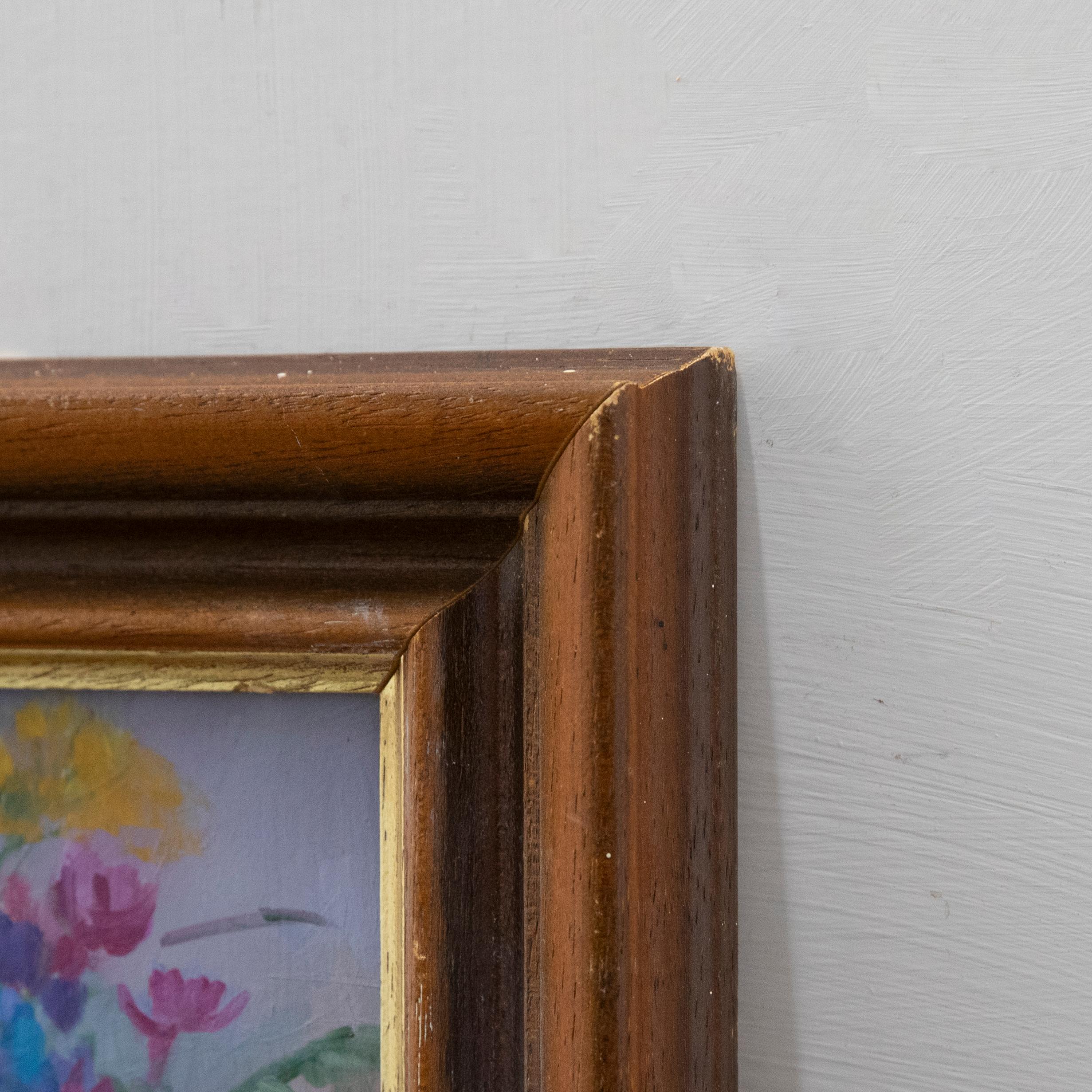 A vibrant still life in oils, showing a bunch of summer flowers displayed in a large glass vase. Well-presented in a charming wood frame. Signed with the artist's monogram to the lower right and full name to the reverse. On board. 