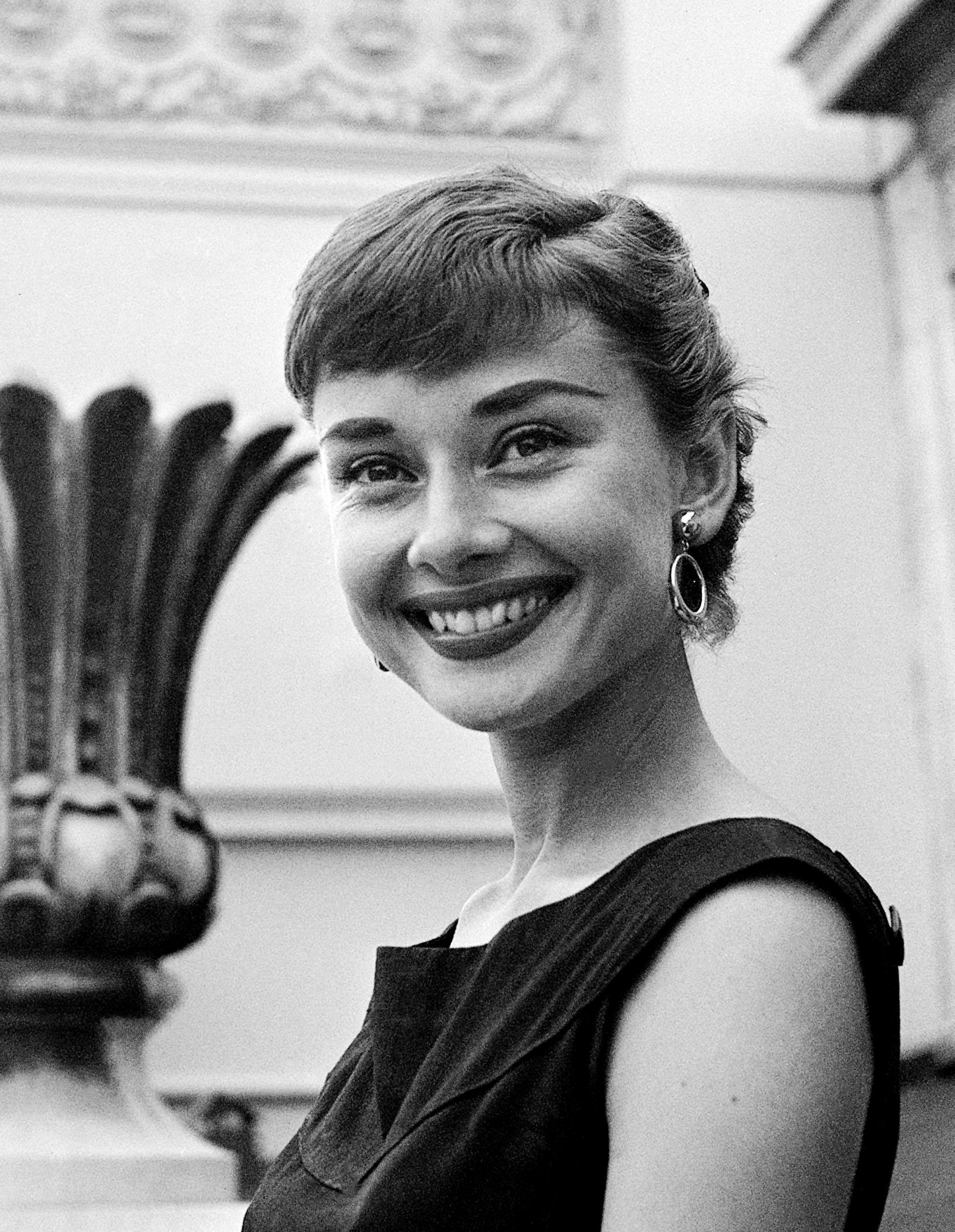 Unknown Black and White Photograph - Audrey Hepburn Candid and Smiling Globe Photos Fine Art Print