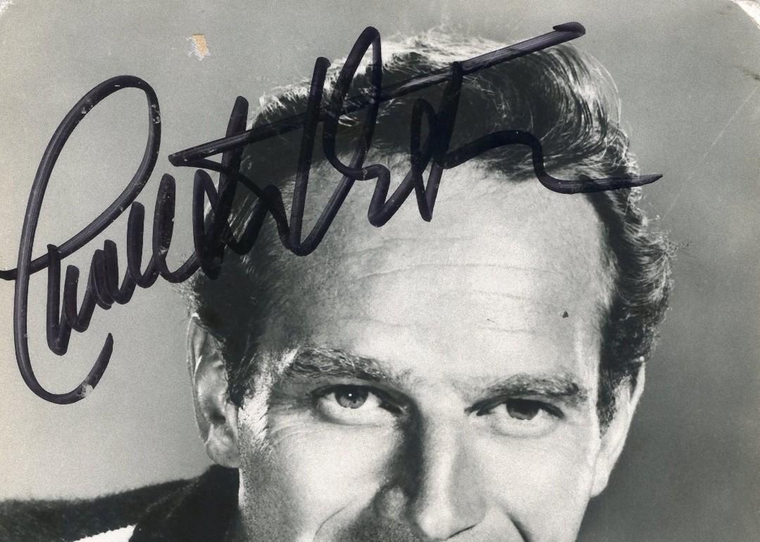 Autographed Portrait of young Charlton Heston - Vintage b/w Postcard - 1950s - Photograph by Unknown