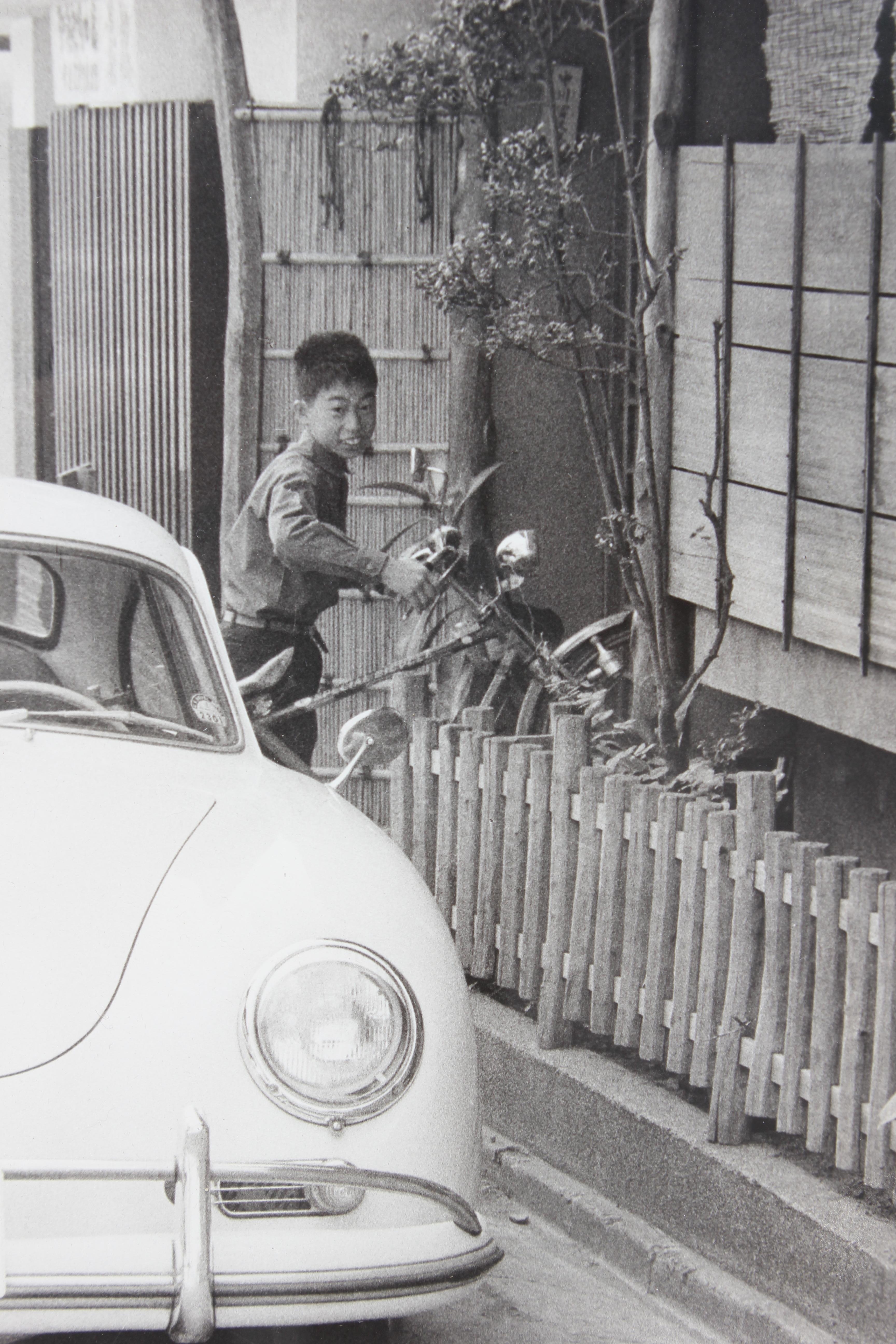 Japanische Schwarz-Weiß-Fotografie eines Porsches und eines Jungen – Photograph von Unknown