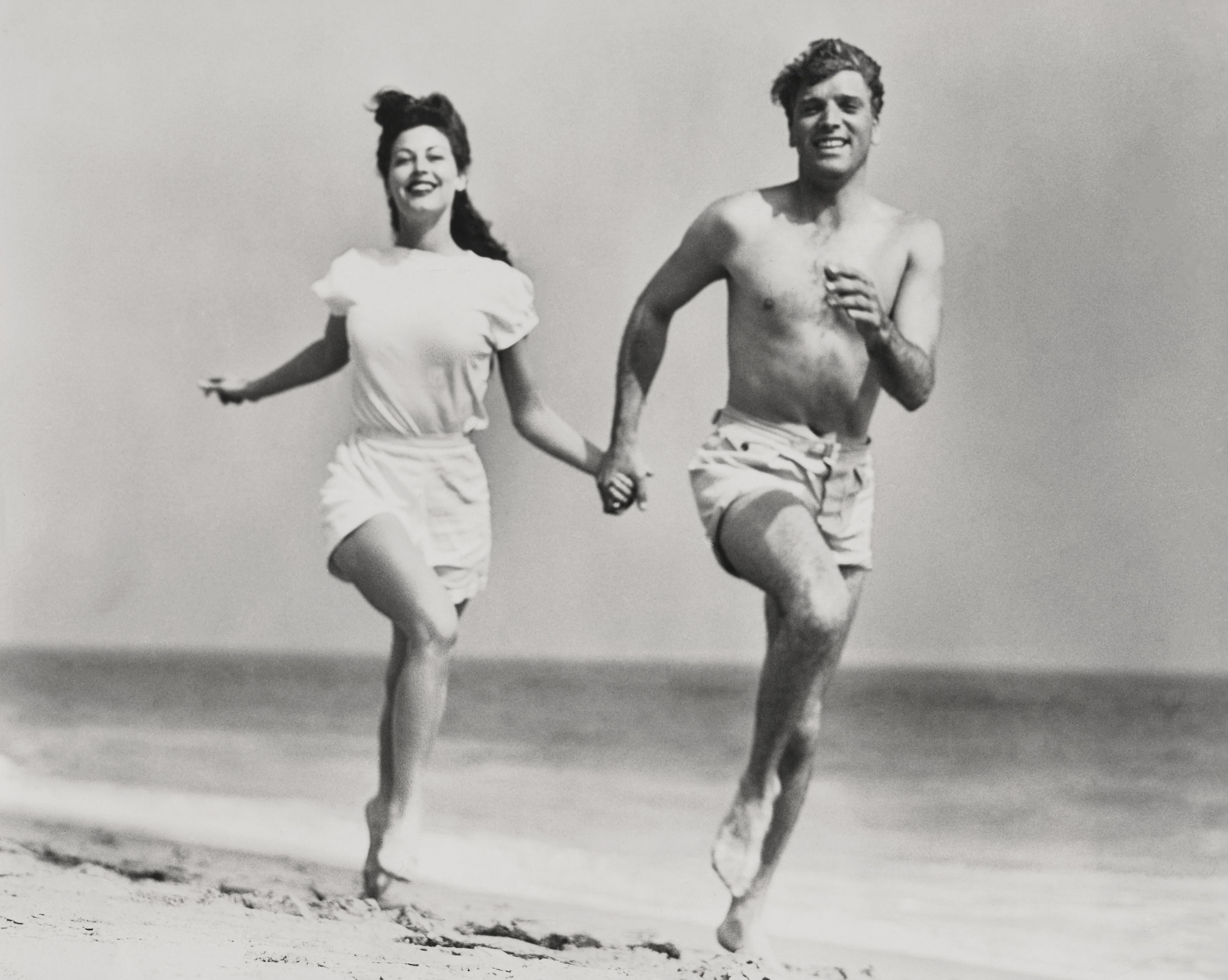 Unknown Portrait Photograph - Burt Lancaster and Ava Gardner Running on the Beach Globe Photos Fine Art Print