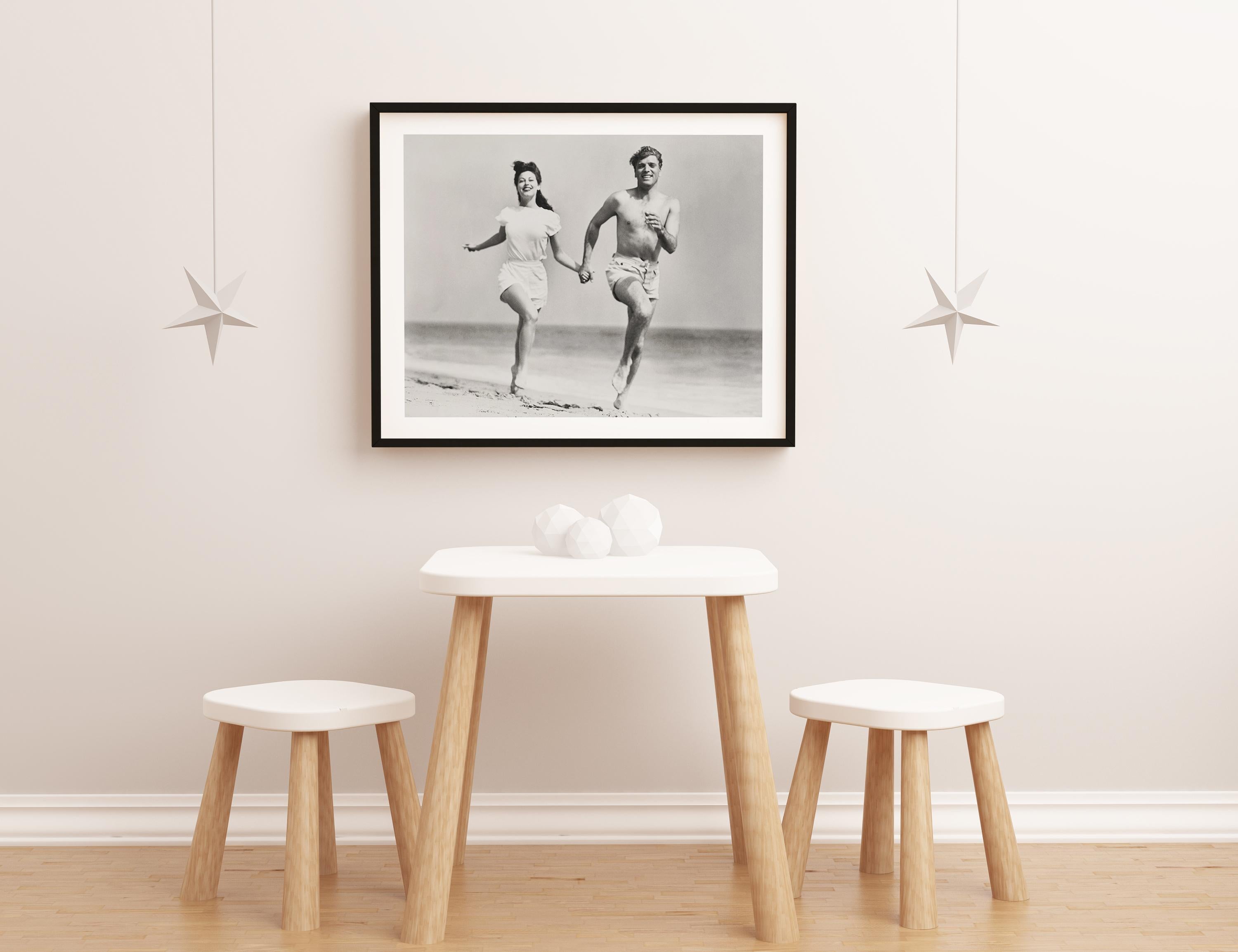 Burt Lancaster and Ava Gardner Running on the Beach Globe Photos Fine Art Print - Gray Portrait Photograph by Unknown