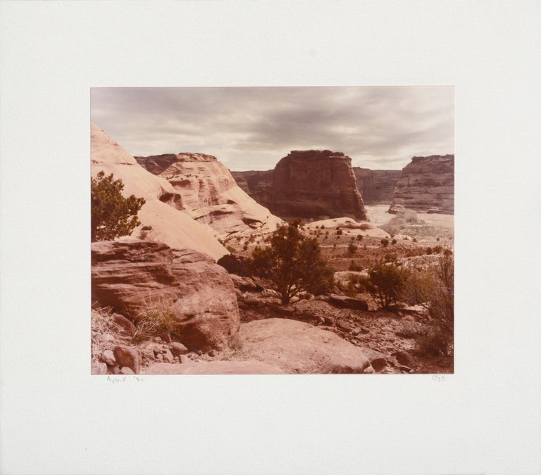 Desert landscape photograph of Canyon de Chelly National Monument by an unknown artist (American, 20th Century). Signed "CJB" in the lower right corner. Dated "April '84" in the lower left corner. Mounted on a heavy white mat. Tag on verso with