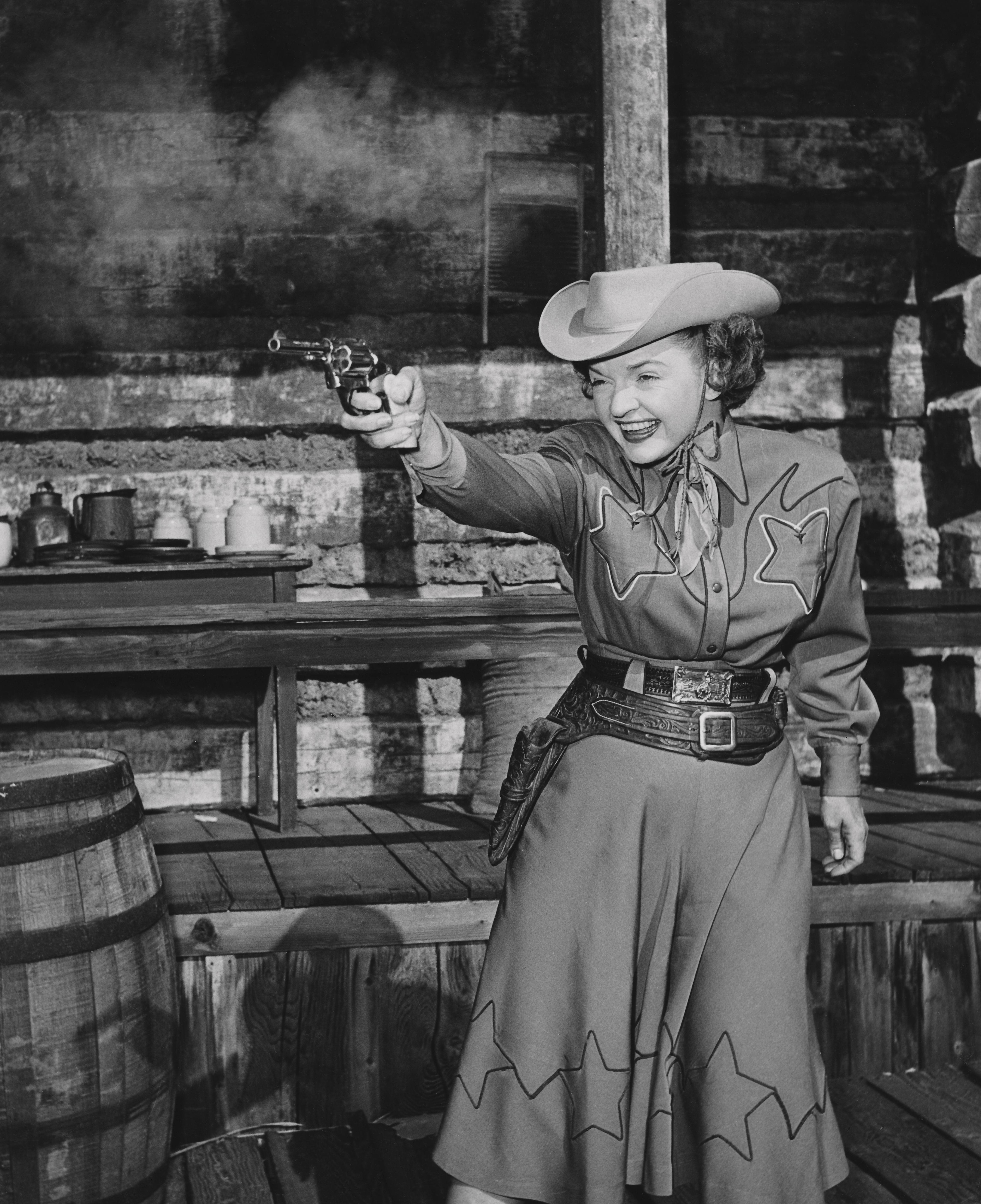 Unknown Black and White Photograph - Dale Evans: Queen of the West Firing Pistol Globe Photos Fine Art Print