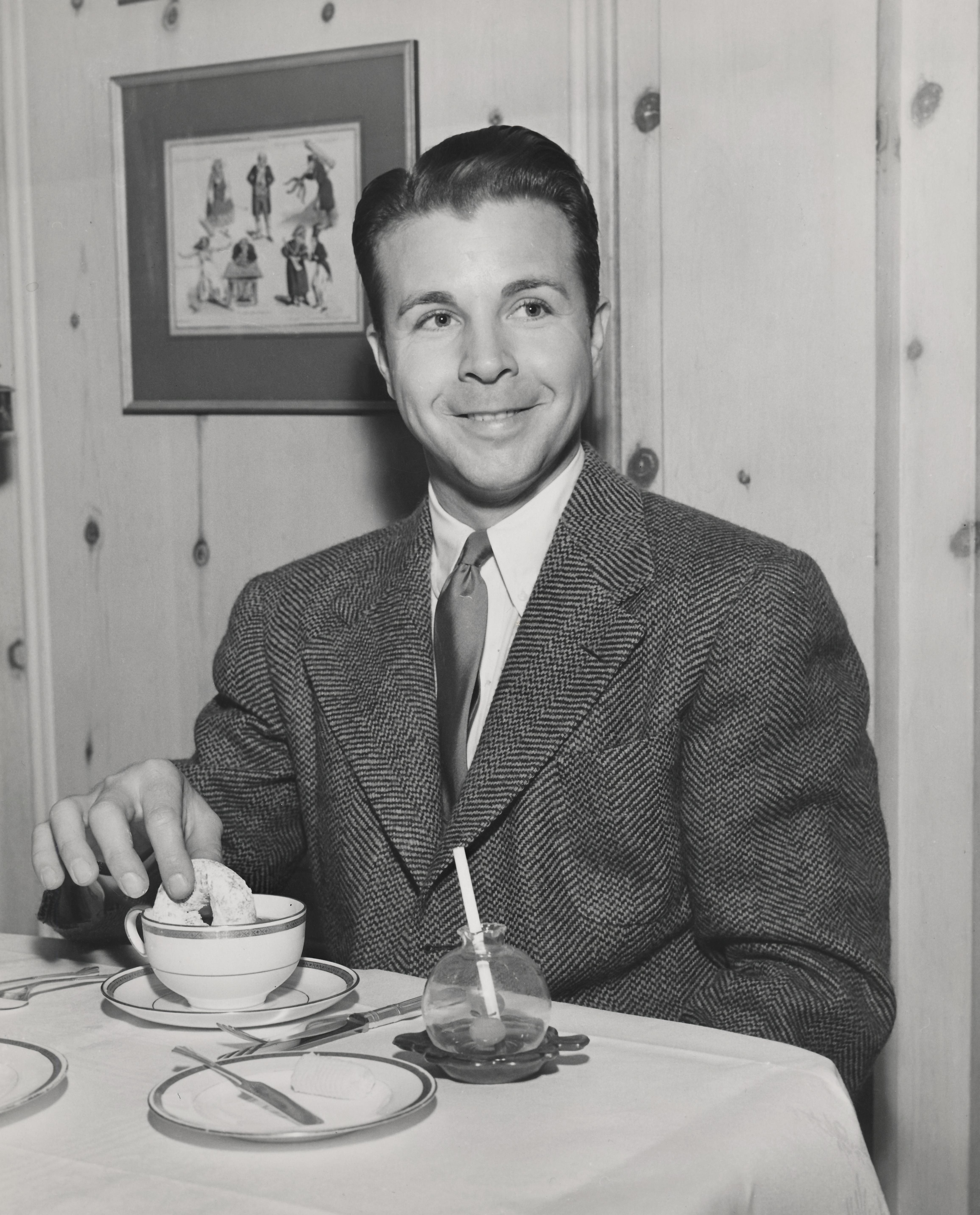 Unknown Black and White Photograph - Dick Powell Dunking a Doughnut Fine Art Print