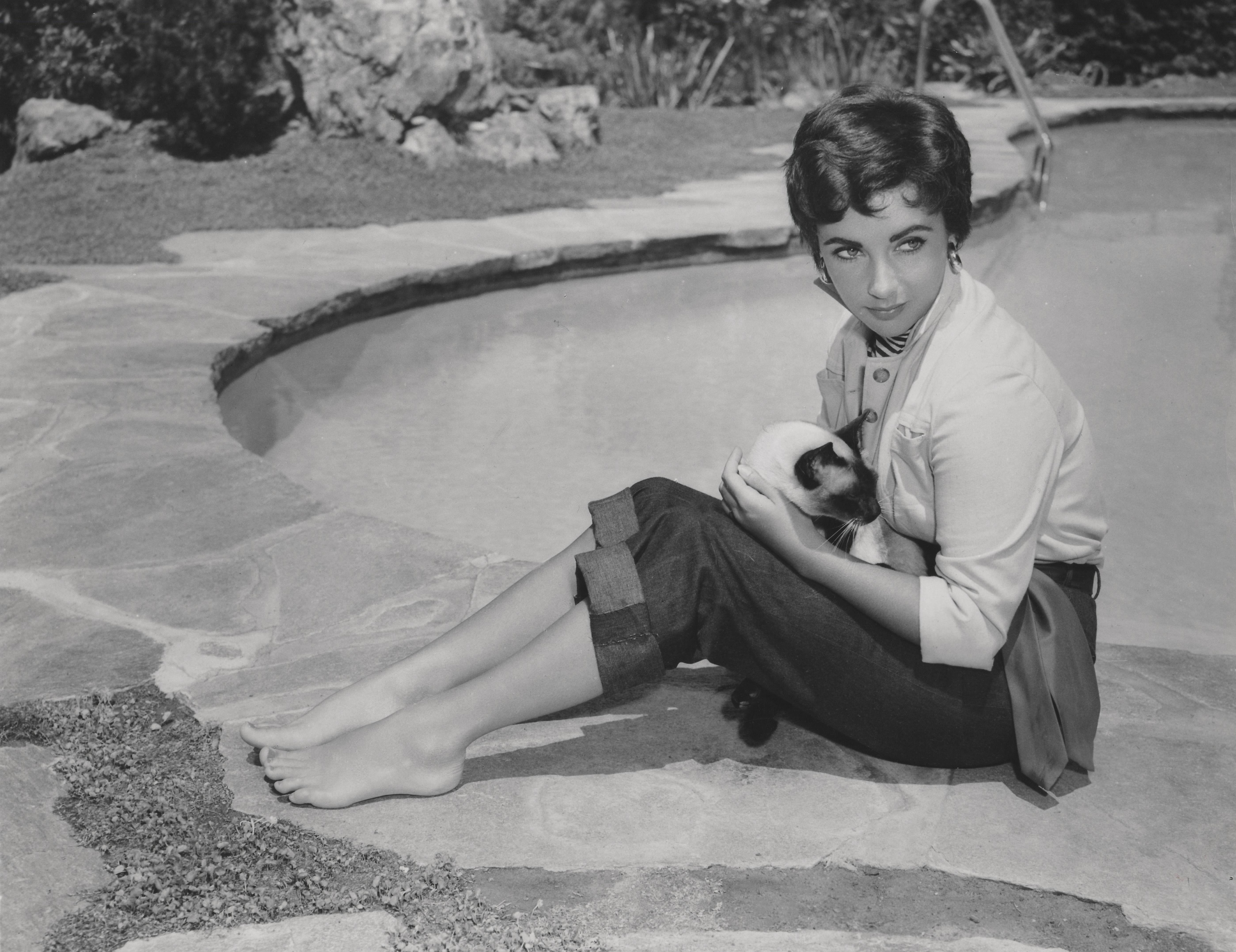 Unknown Black and White Photograph - Elizabeth Taylor Holding Cat Poolside Fine Art Print