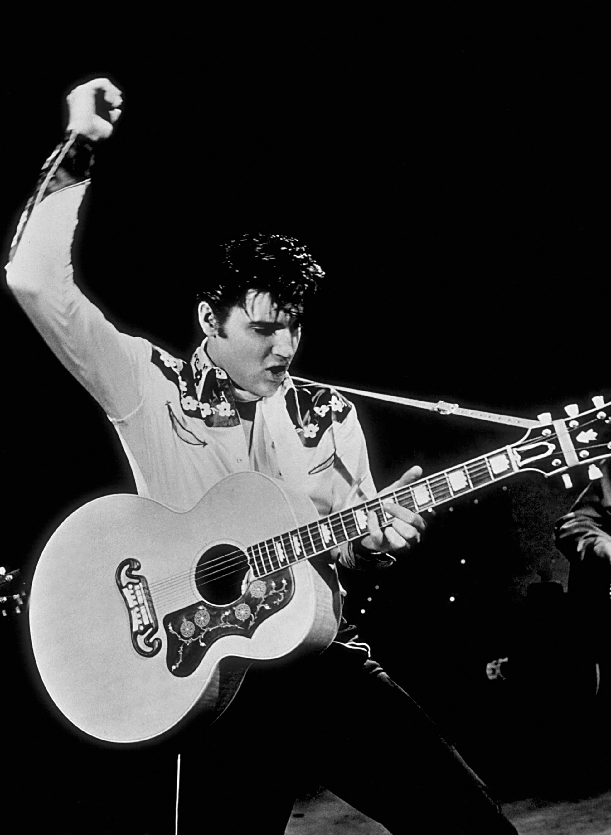 Unknown Black and White Photograph - Elvis Presley Playing Guitar on Stage Globe Photos Fine Art Print