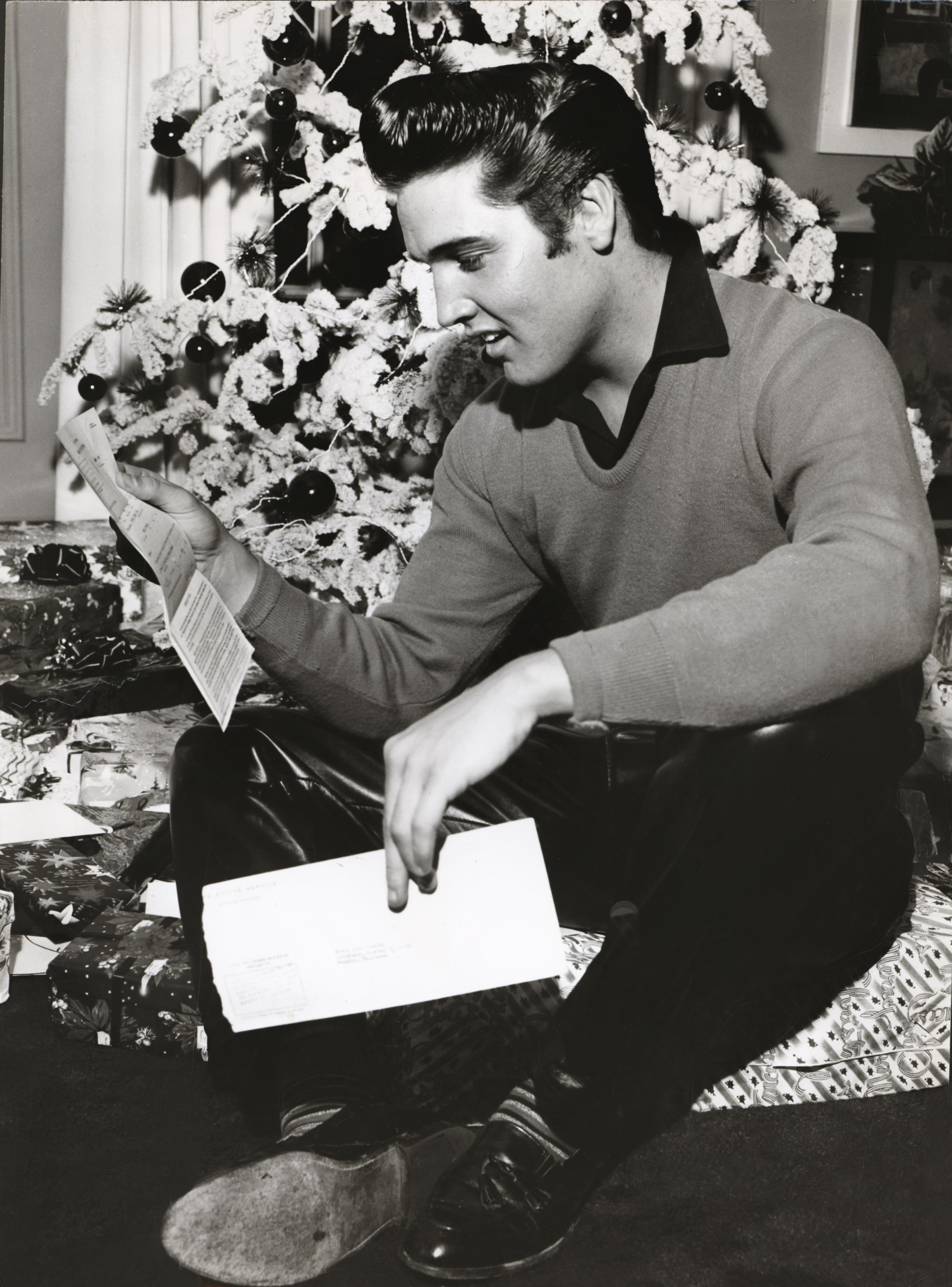 Unknown Black and White Photograph - Elvis Presley Reading Fan Mail by the Christmas Tree Fine Art Print