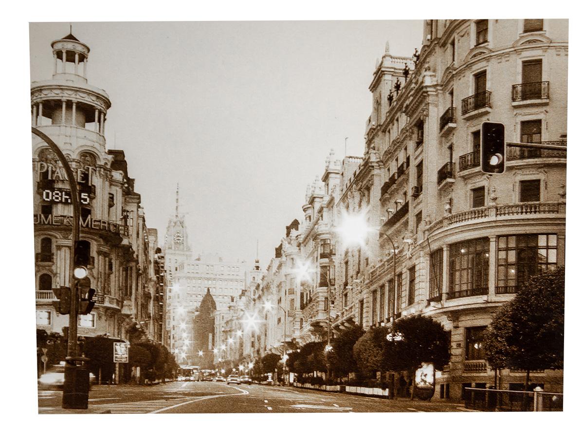 This timeless photographic print captures the quiet grandeur of a Parisian boulevard, rendered in warm sepia tones that evoke a sense of nostalgia and romance. The perspective draws the viewer into the scene, where classic Haussmannian architecture