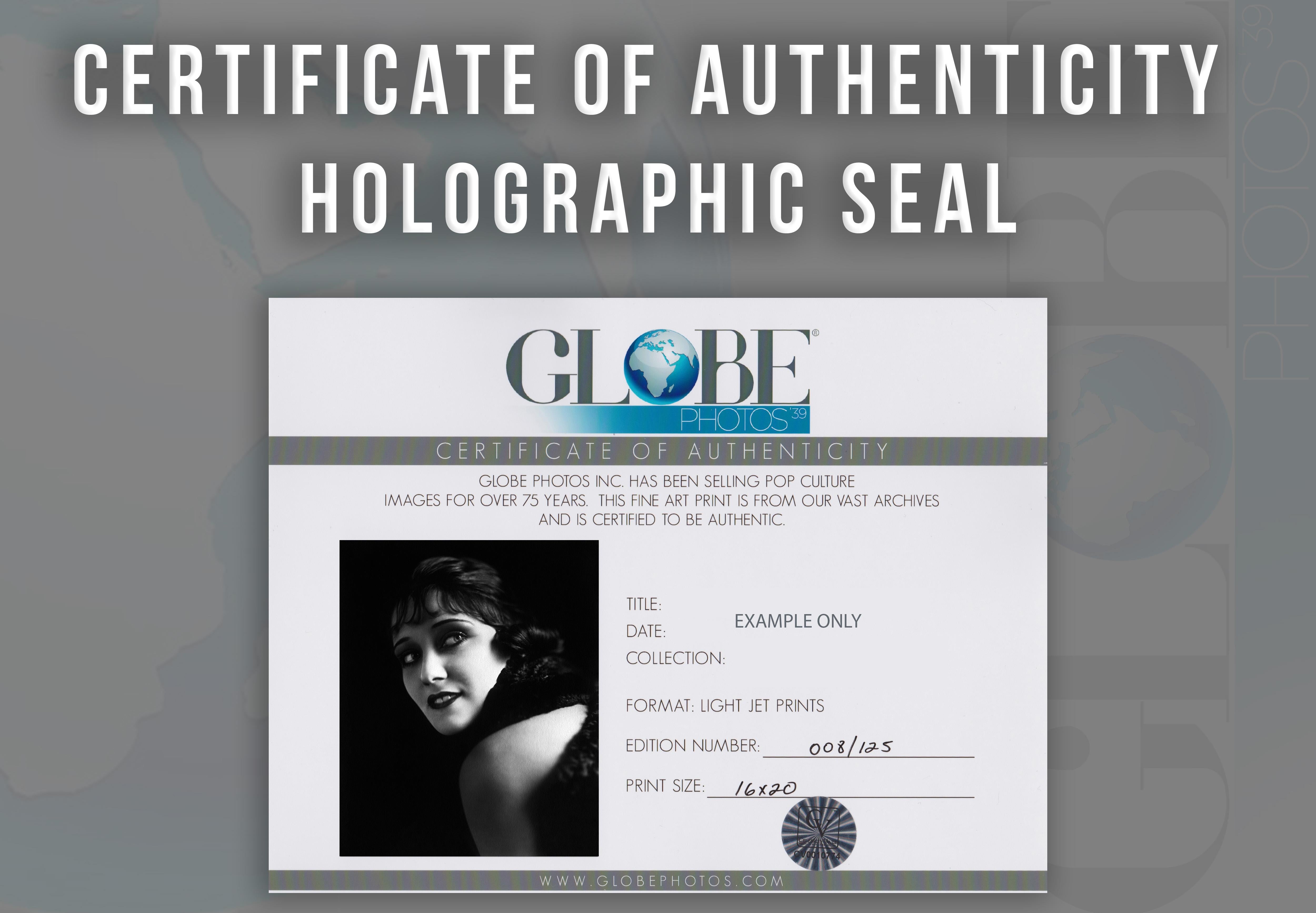 Gloria Swanson Smiling Over Shoulder Globe Photos Fine Art Print - Black Black and White Photograph by Unknown