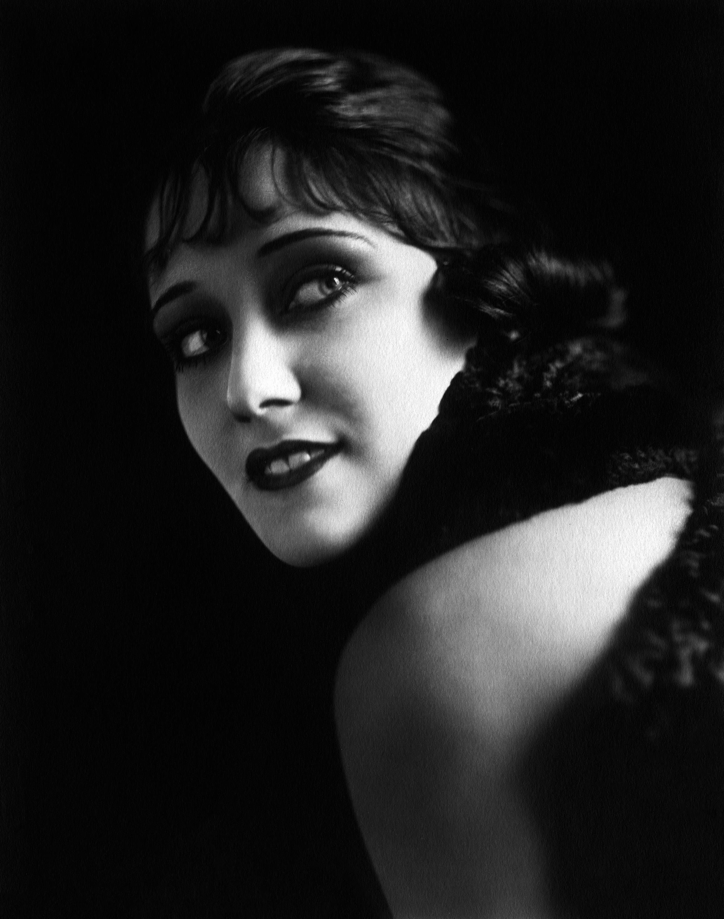 Unknown Black and White Photograph - Gloria Swanson Smiling Over Shoulder Globe Photos Fine Art Print