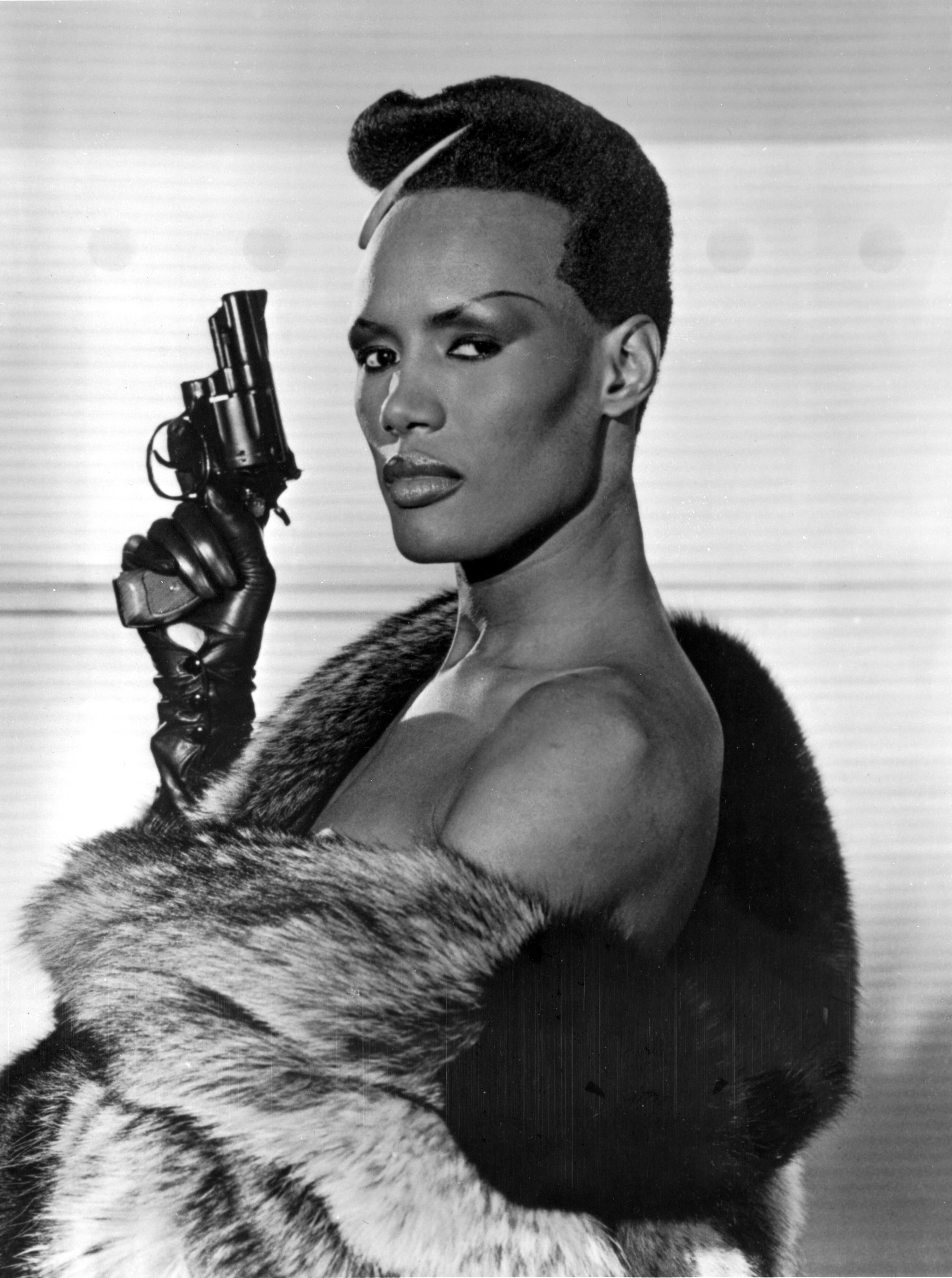 Unknown Portrait Photograph - Grace Jones Holding Pistol