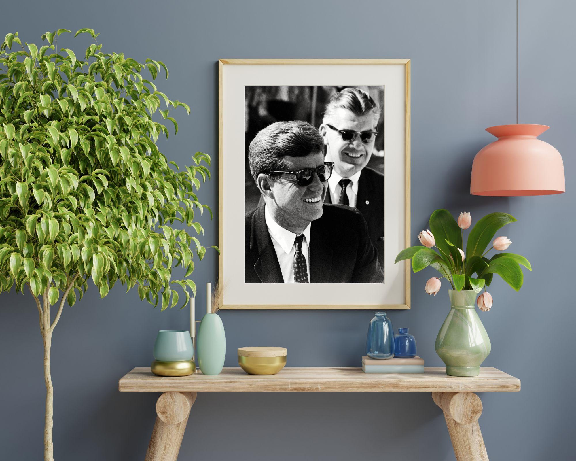 John F. Kennedy che sorride con gli occhiali da sole - Photograph di Unknown