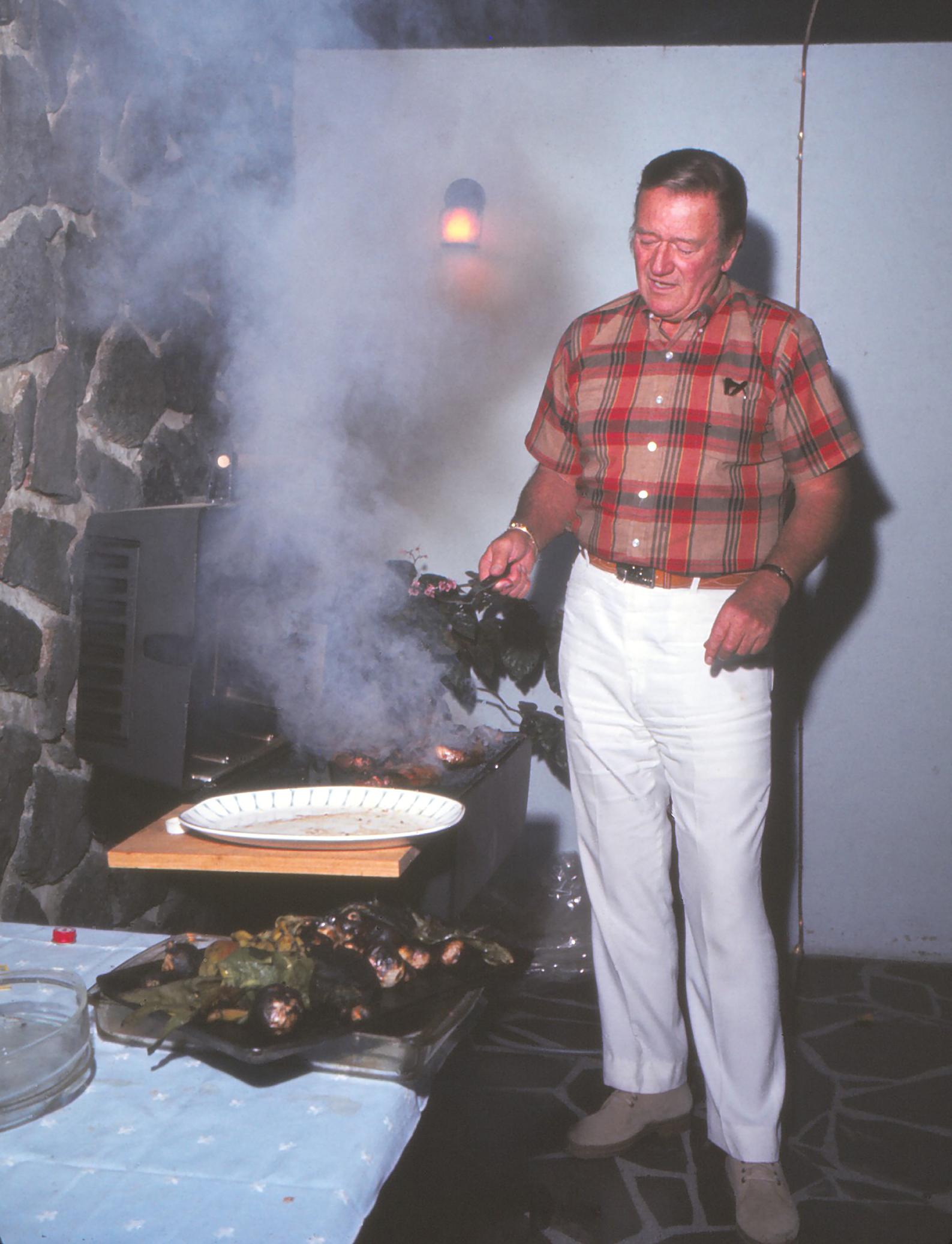 Unknown Portrait Photograph - John Wayne Cooking on Grill