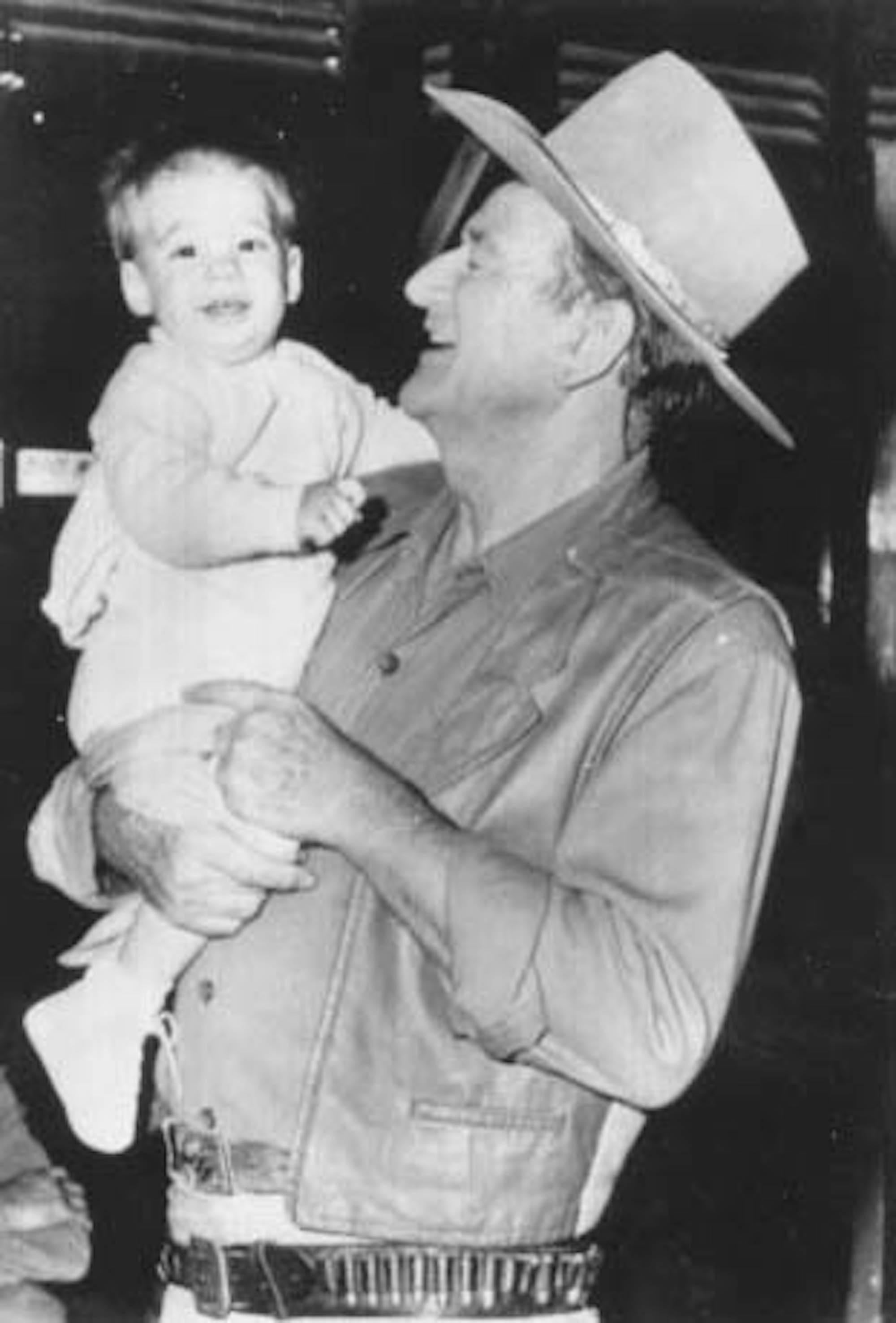 Unknown Figurative Photograph - John Wayne with his grandson - Vintage Photo - 1970s
