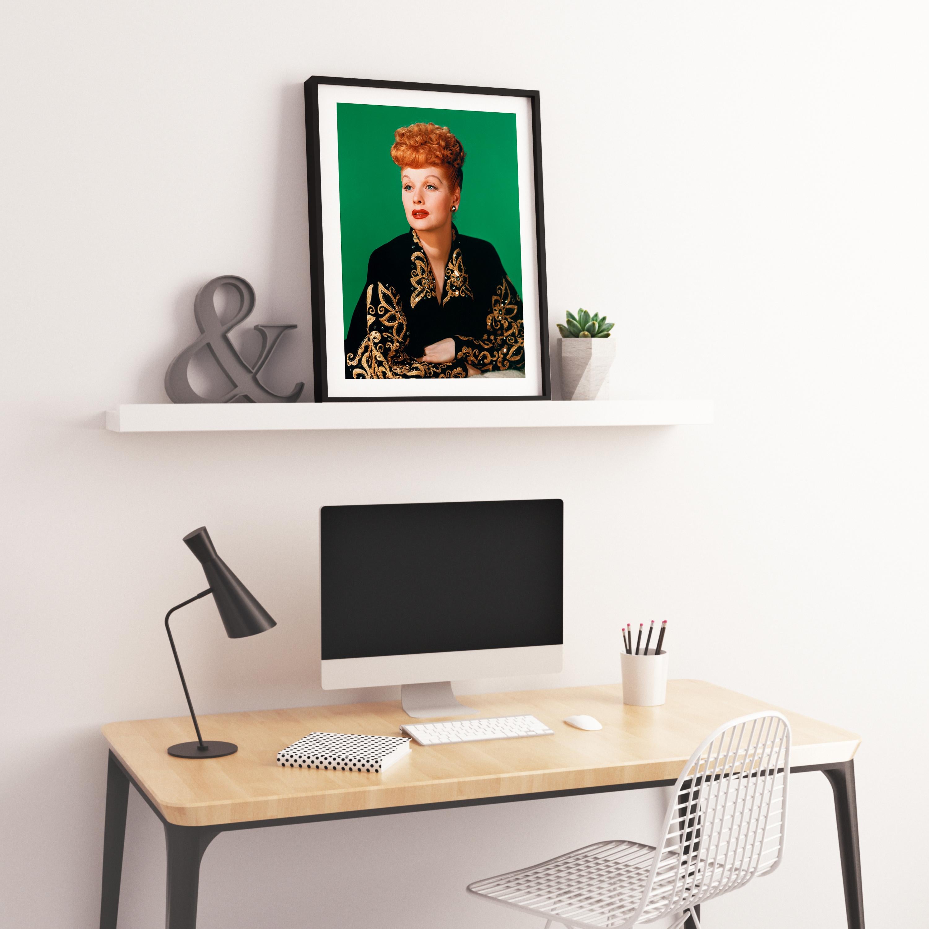 This awesome color capture features Lucille Ball posed in the studio, smiling against a green background.

Lucille Ball was an American actress, comedian, model, entertainment studio executive, and producer. She was the star of the self-produced