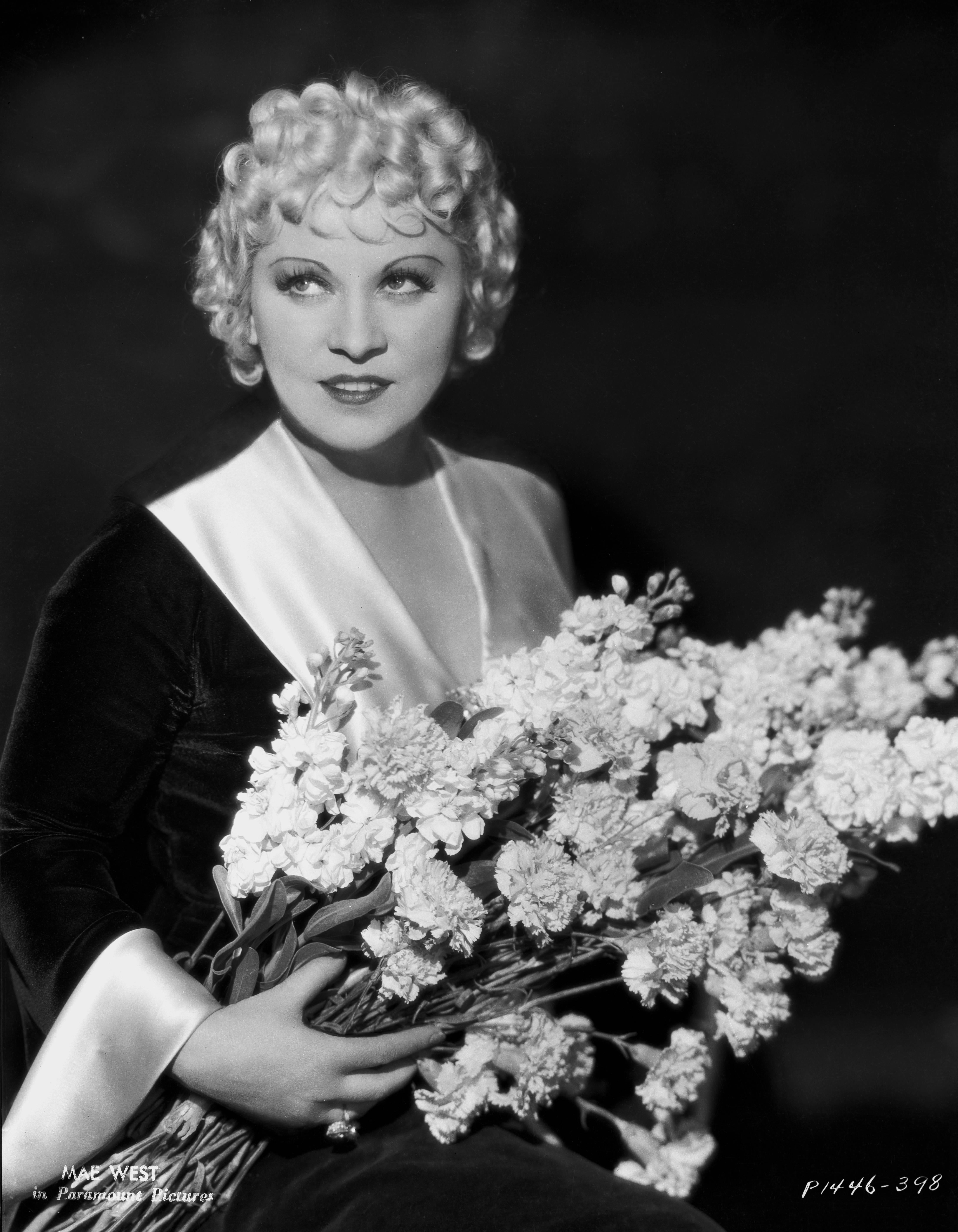 Unknown Black and White Photograph - Mae West Holding Flowers Fine Art Print