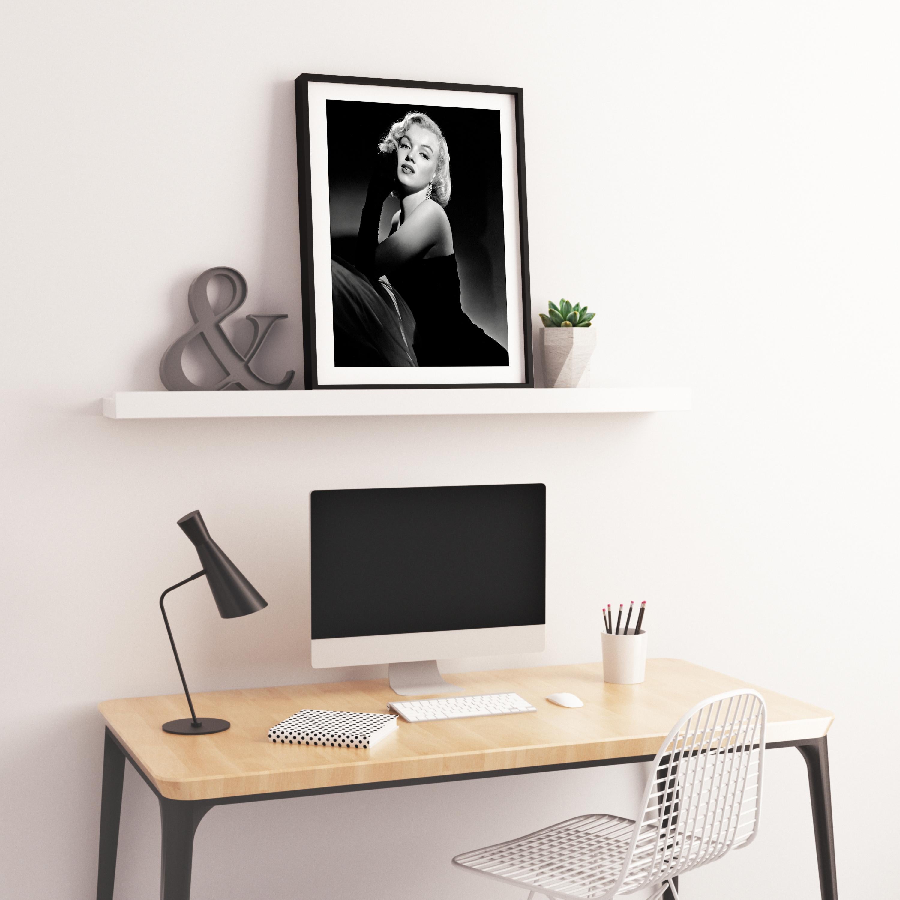 This black and white pinup portrait features Marilyn Monroe in the studio, posed in long black gloves.

Marilyn Monroe was an American actress, model, and singer. Famous for playing comic 