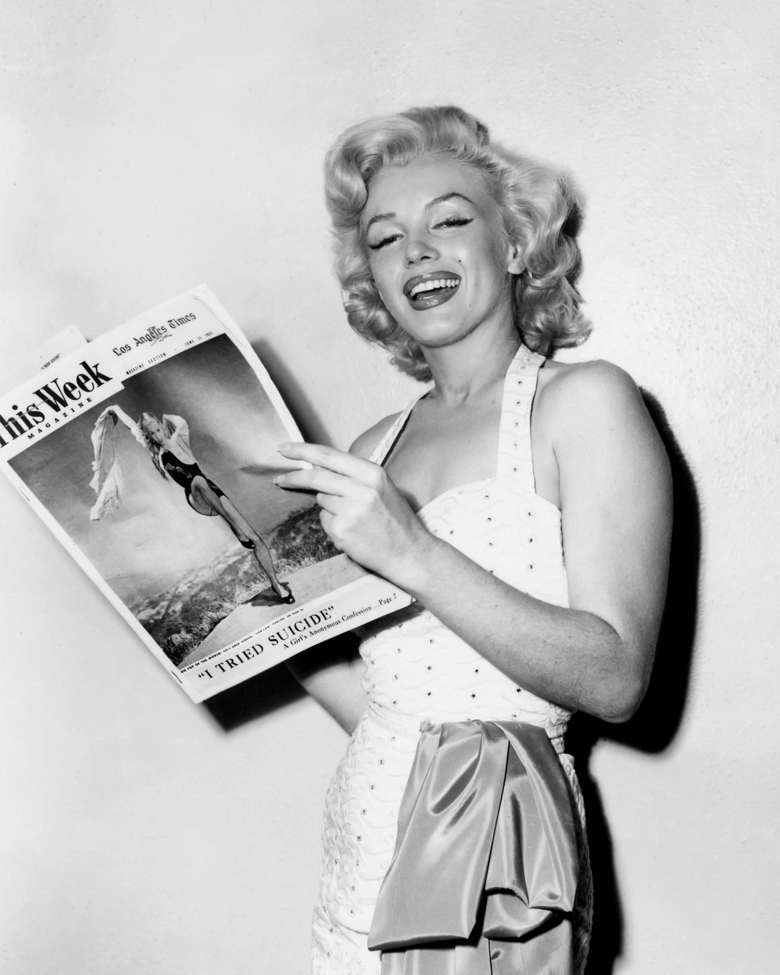 Unknown Portrait Photograph - Marilyn Monroe Smling with Magazine Globe Photos Fine Art Print