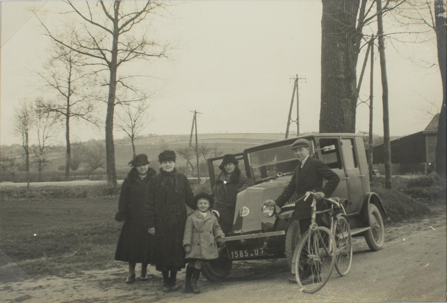 A unique original silver gelatin black and white photograph. A family on the road near Paris, France, circa 1930. The car in the background is a Renault KZ. 
Features:
Original Silver Gelatin Print Photography Unframed.
Press Photography.
Press