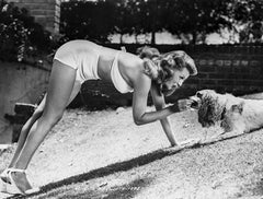 Rita Hayworth che dà da mangiare a un cane