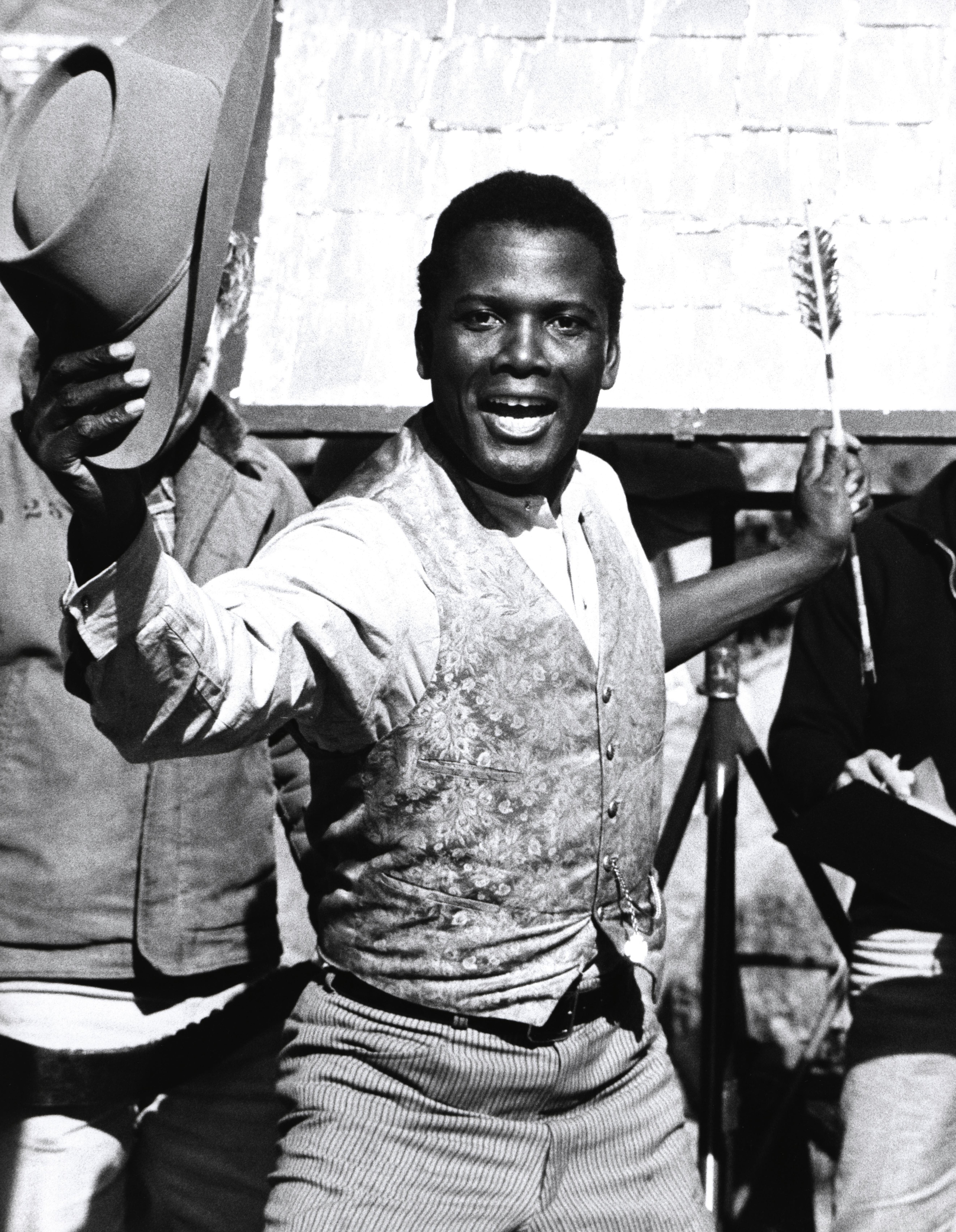Unknown Black and White Photograph - Sidney Poitier with Cowboy Hat and Arrow Fine Art Print