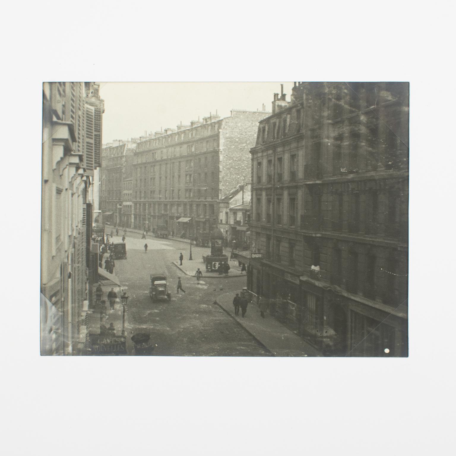 A unique original silver gelatin black and white photography. A street view in Paris, France, circa 1930. 
Features:
Original Silver Gelatin Print Photography Unframed.
Press Photography.
Press Agency: Anonymous.
Photographer: Anonymous.
Title: