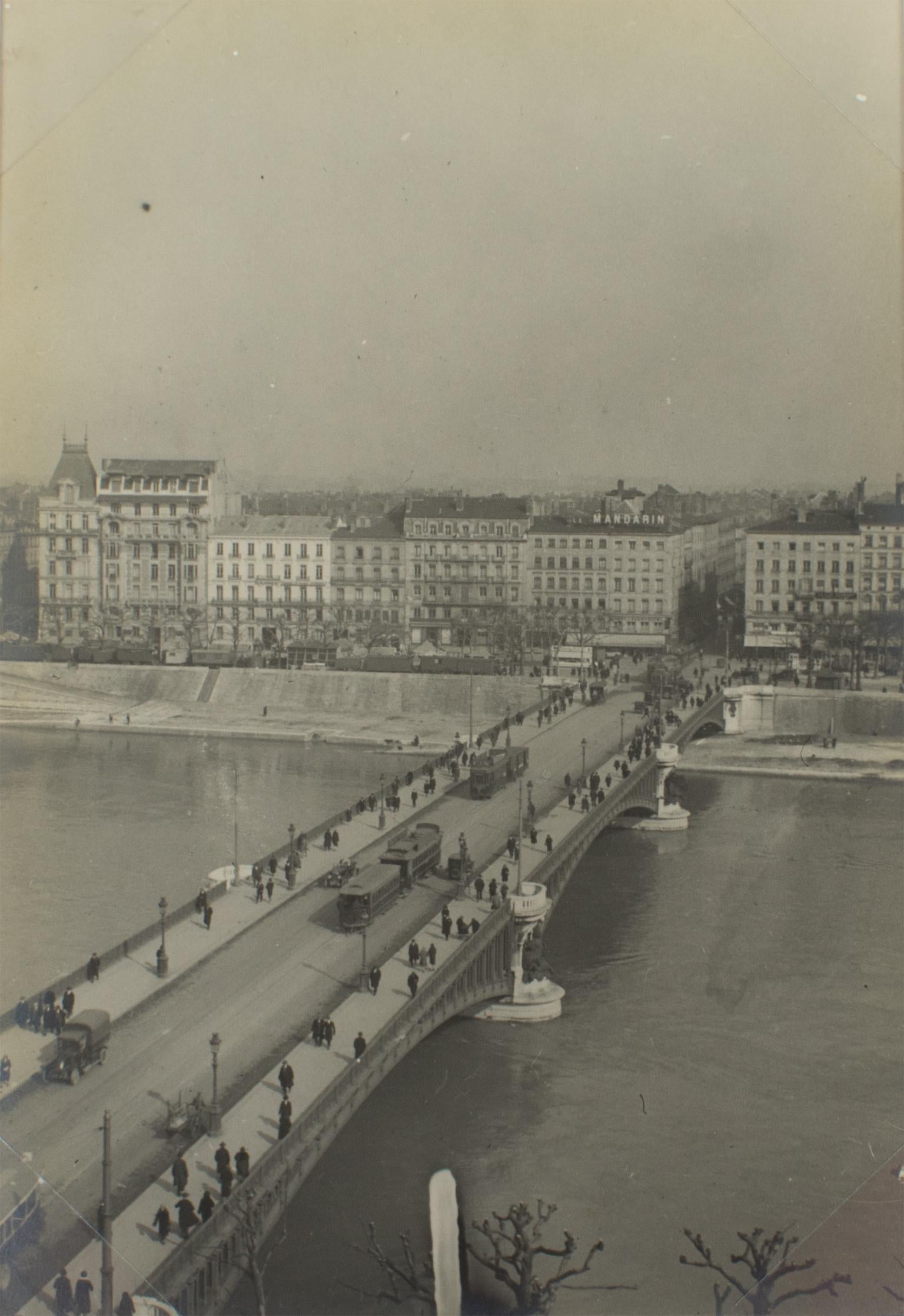 A unique original silver gelatin black and white photograph. View of a bridge in Lyon, France, March 1927. 
This view of the Pont de l'Université in Lyon, France, was taken from the roof of The Galerie Lafayette Department Store. The photograph is