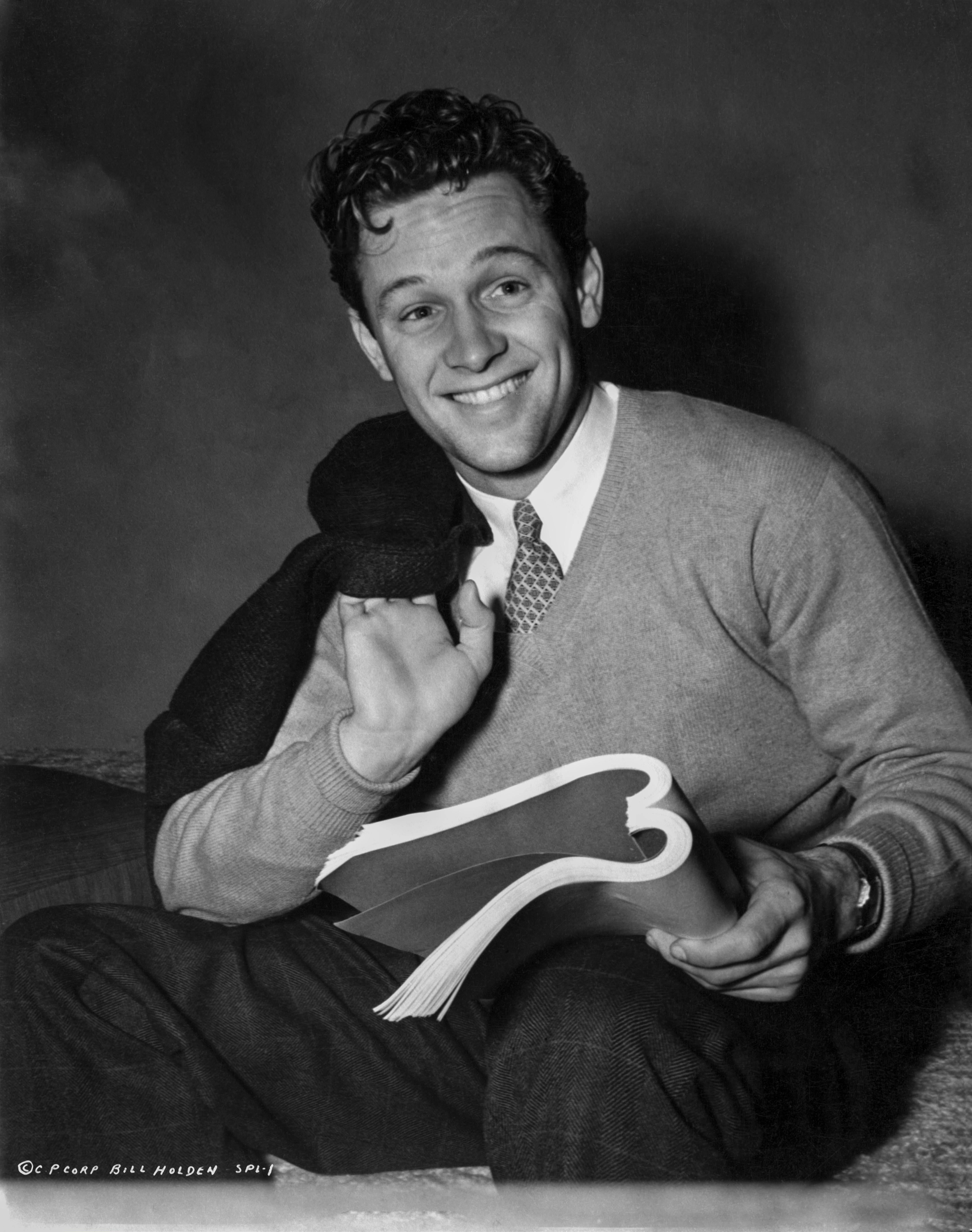 Unknown Black and White Photograph - William Holden Smiling With Book in Hand Fine Art Print