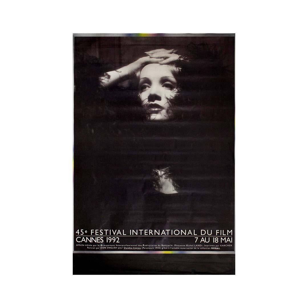 The 1992 Cannes Film Festival chose to celebrate its 45th edition with an image of timeless glamour and cinematic history: a striking black-and-white portrait of Marlene Dietrich, the legendary icon of the silver screen.

Designed by the Groupement