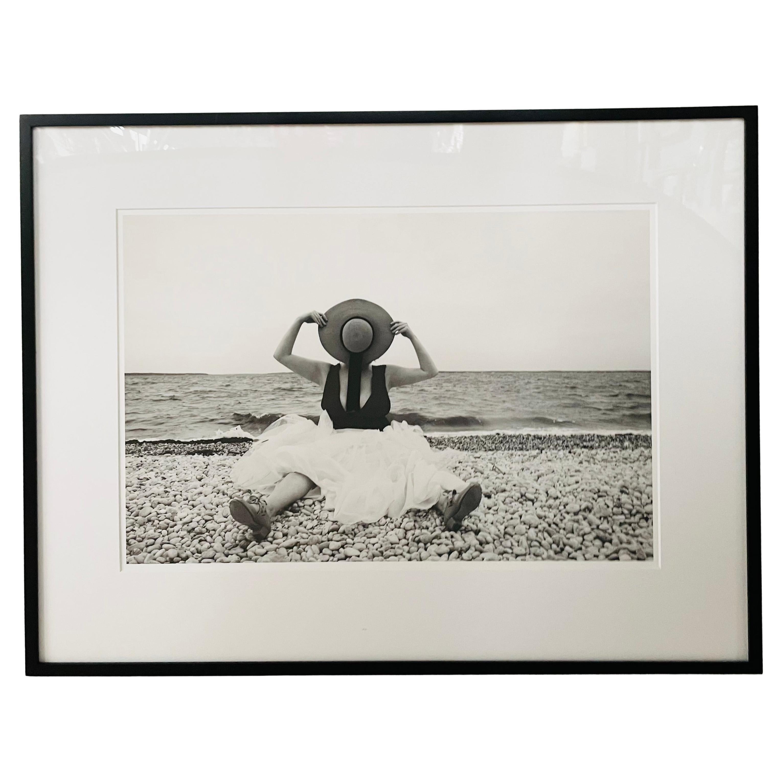 A contemporary portrait of a woman titled "Straw hat" by Luciana Pampalone ( American, 1963). The archival pigment print is made in black and white and part of Pampalone's Hamptons vintage collection series. The limited edition print is the first