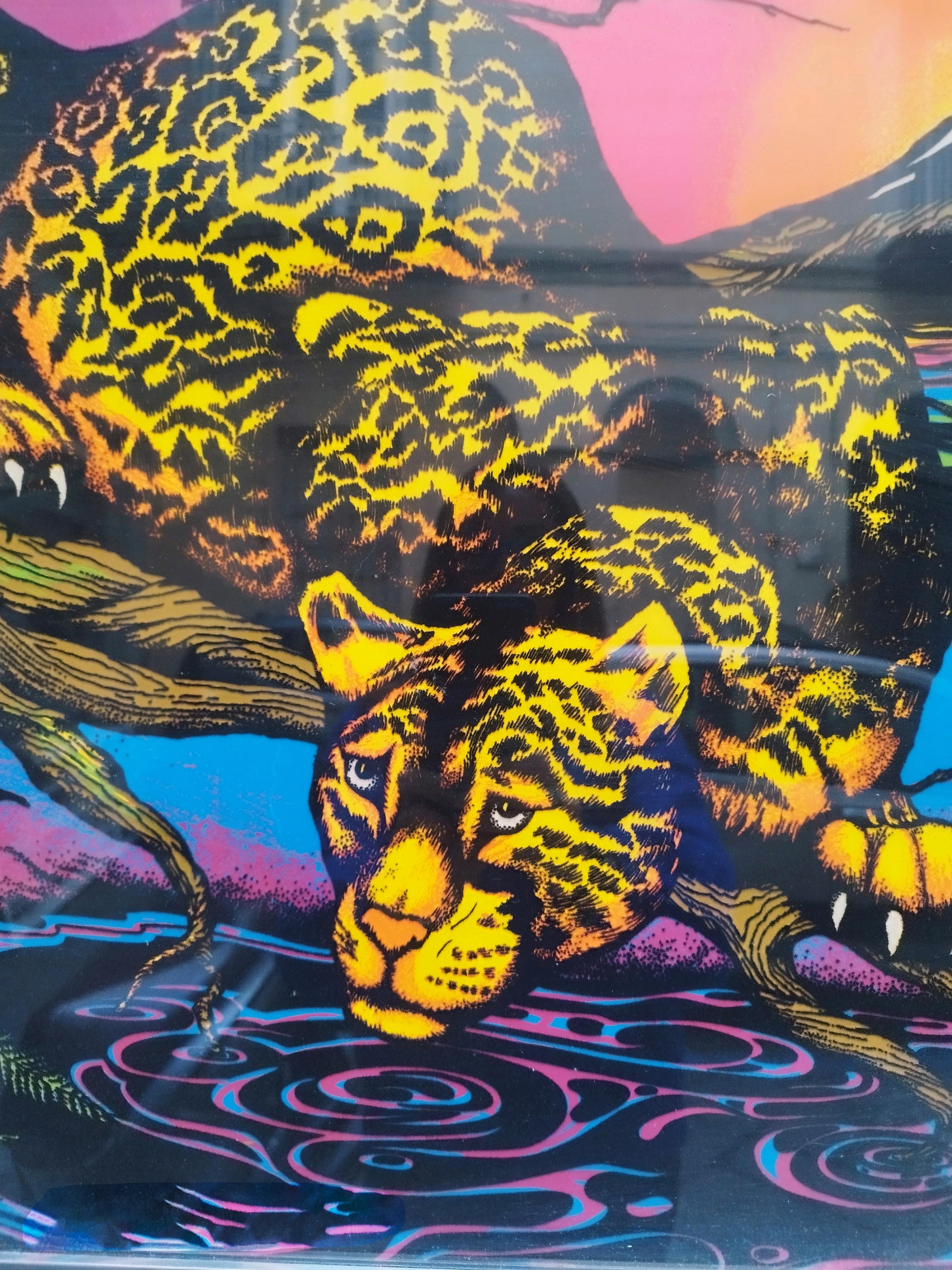An original black light, silkscreen and lithograph poster from the 1970s published by AA Sales inc. from Seattle, Washington. The poster depicts a jaguar resting on a tree branch reaching out and diving into a tranquil lake. His eyes seem fixed in a