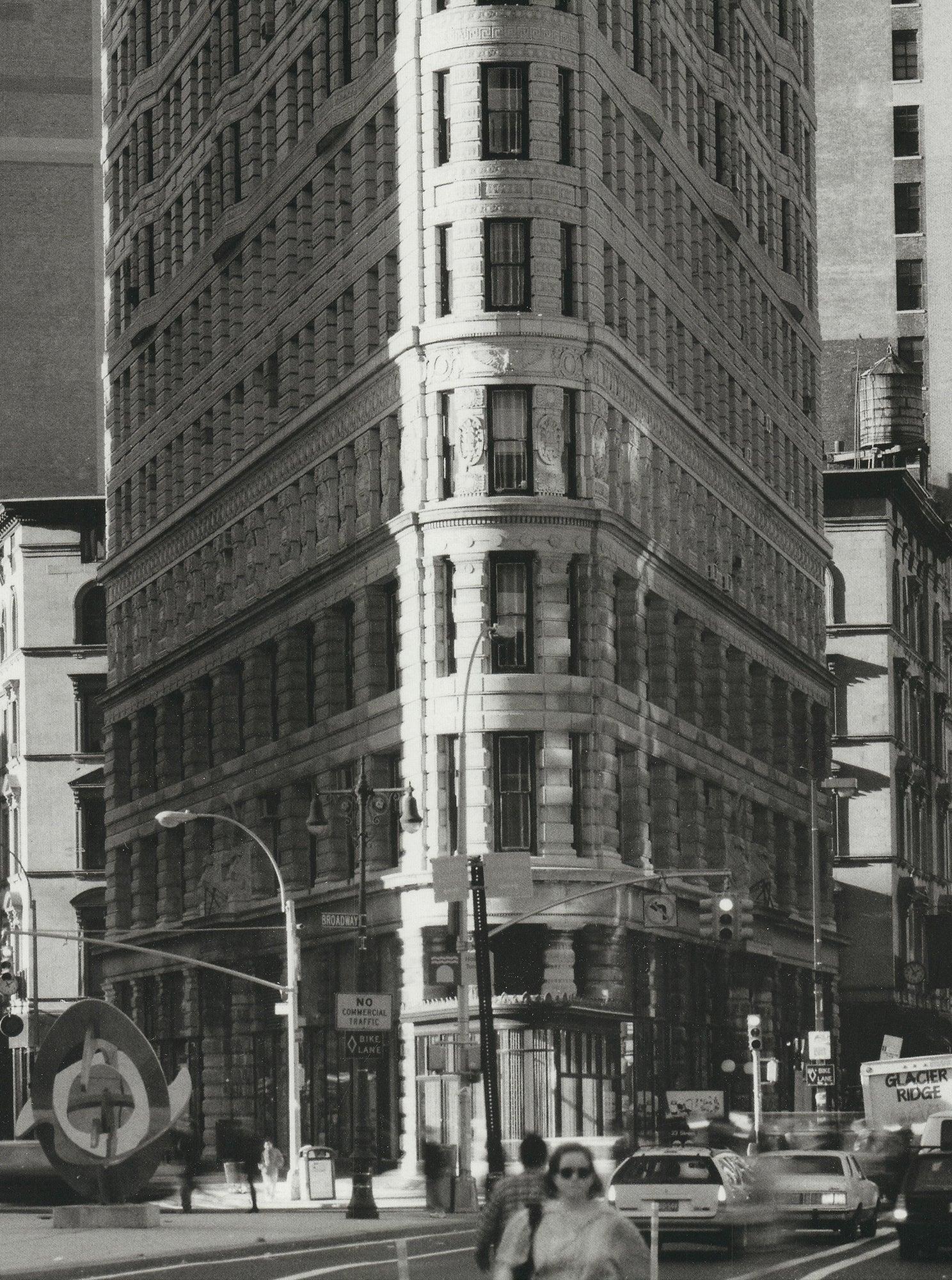 Original 1998 poster featuring Henri Silberman’s iconic photograph of the Flatiron Building in New York. Printed in Switzerland, this edition captures the landmark shortly after its restoration, revealing the building’s original pale limestone